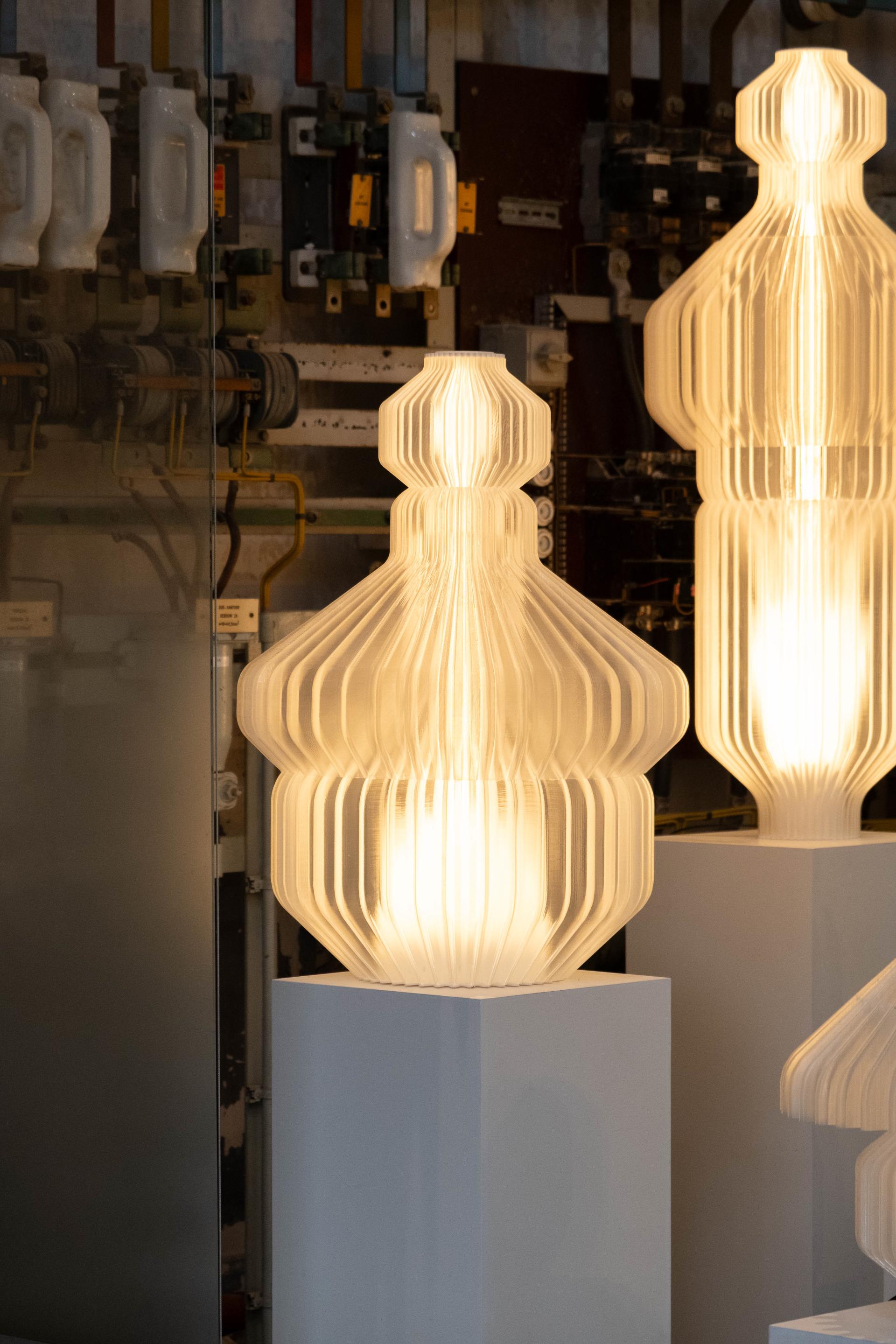 Elegant, sculptural lamps warm the space with soft light at Dutch Design Week 2024, showcasing innovative design and craftsmanship.