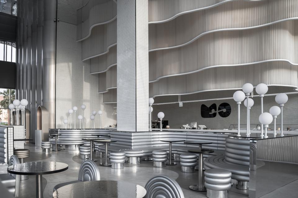 Modern interior of MO bakehouse and espresso bar in Khobar, featuring sleek metallic seating and elegant lighting design.