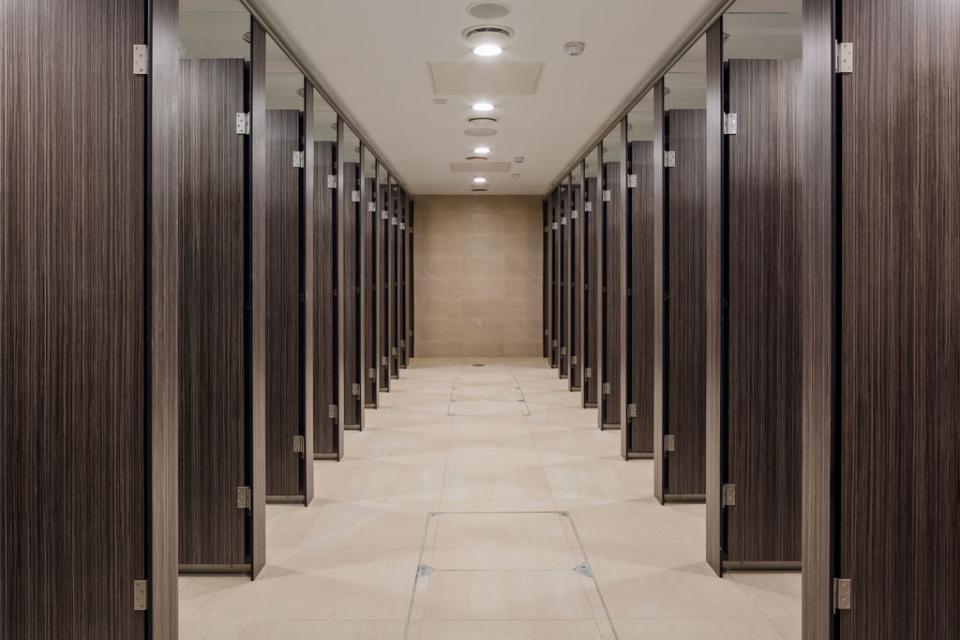 Modern washroom stalls in Liverpool Street Station, showcasing a sleek transformation for enhanced passenger experience.
