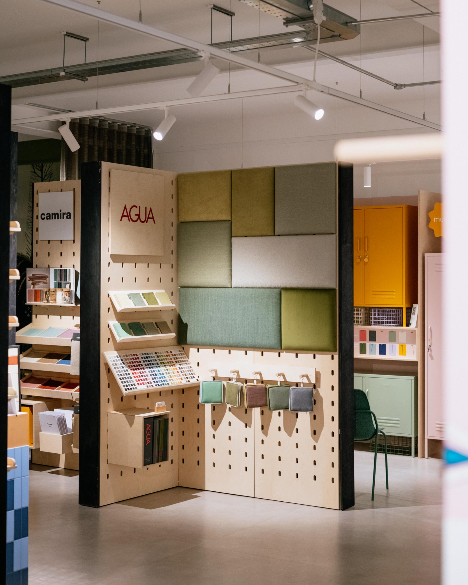 Modern showroom display featuring Agua's Eden and Bouclé performance upholstery samples in stylish colors and textures.