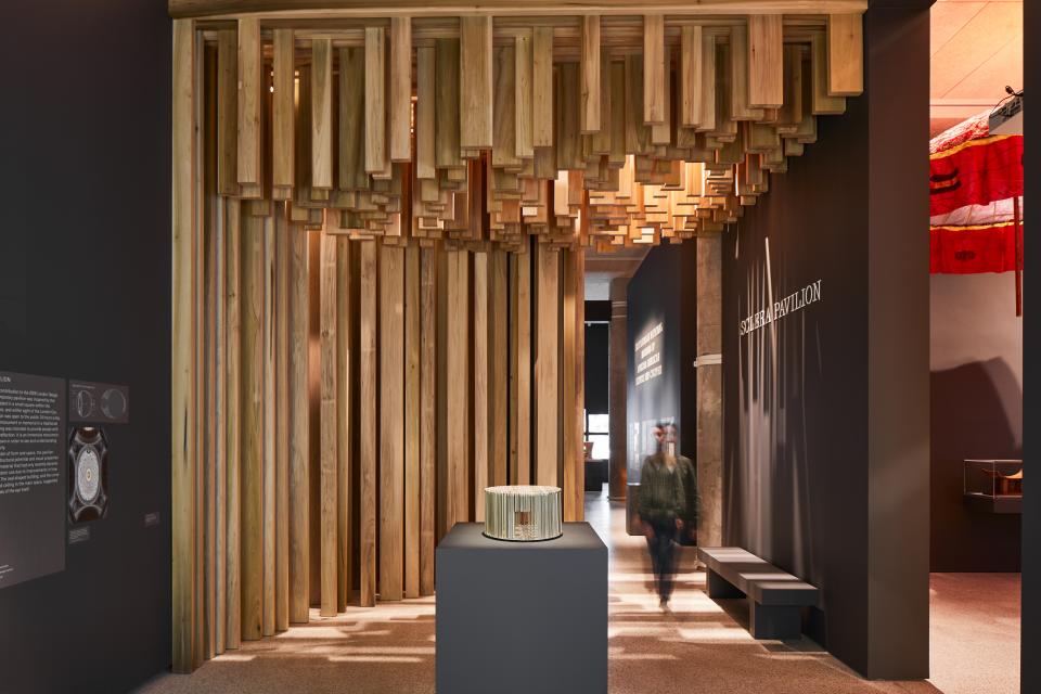 Intricately designed American Tulipwood Pavilion featured in David Adjaye's exhibition, showcasing innovative wood architecture at the Design Museum.