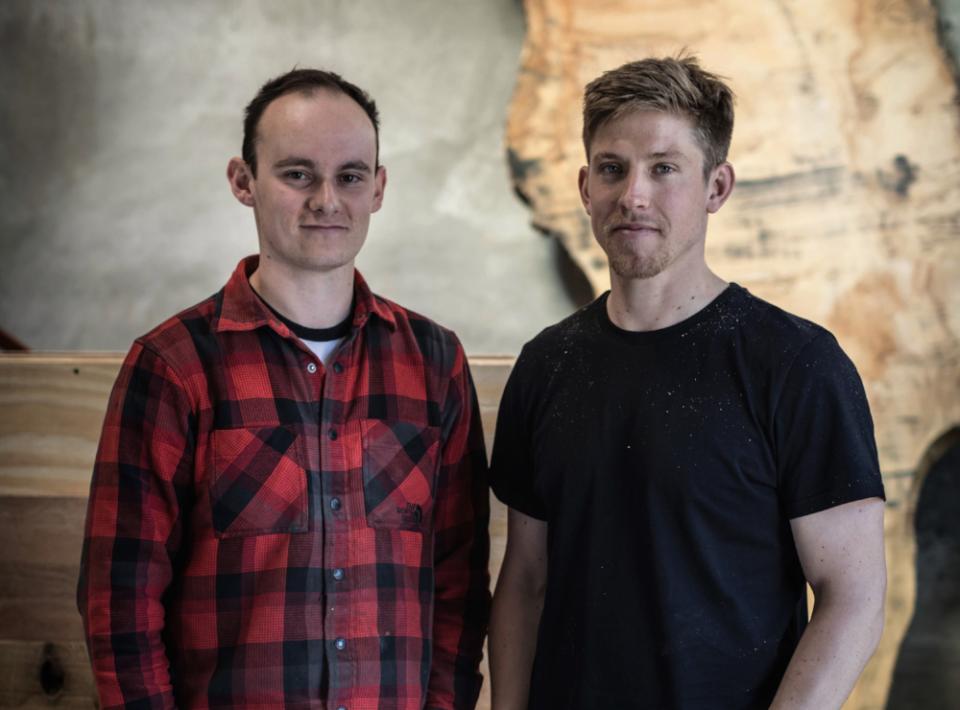 Louis Higgins and Ed Wilson of Takumi Woodwork pose in their workshop, showcasing craftsmanship and love for wood.