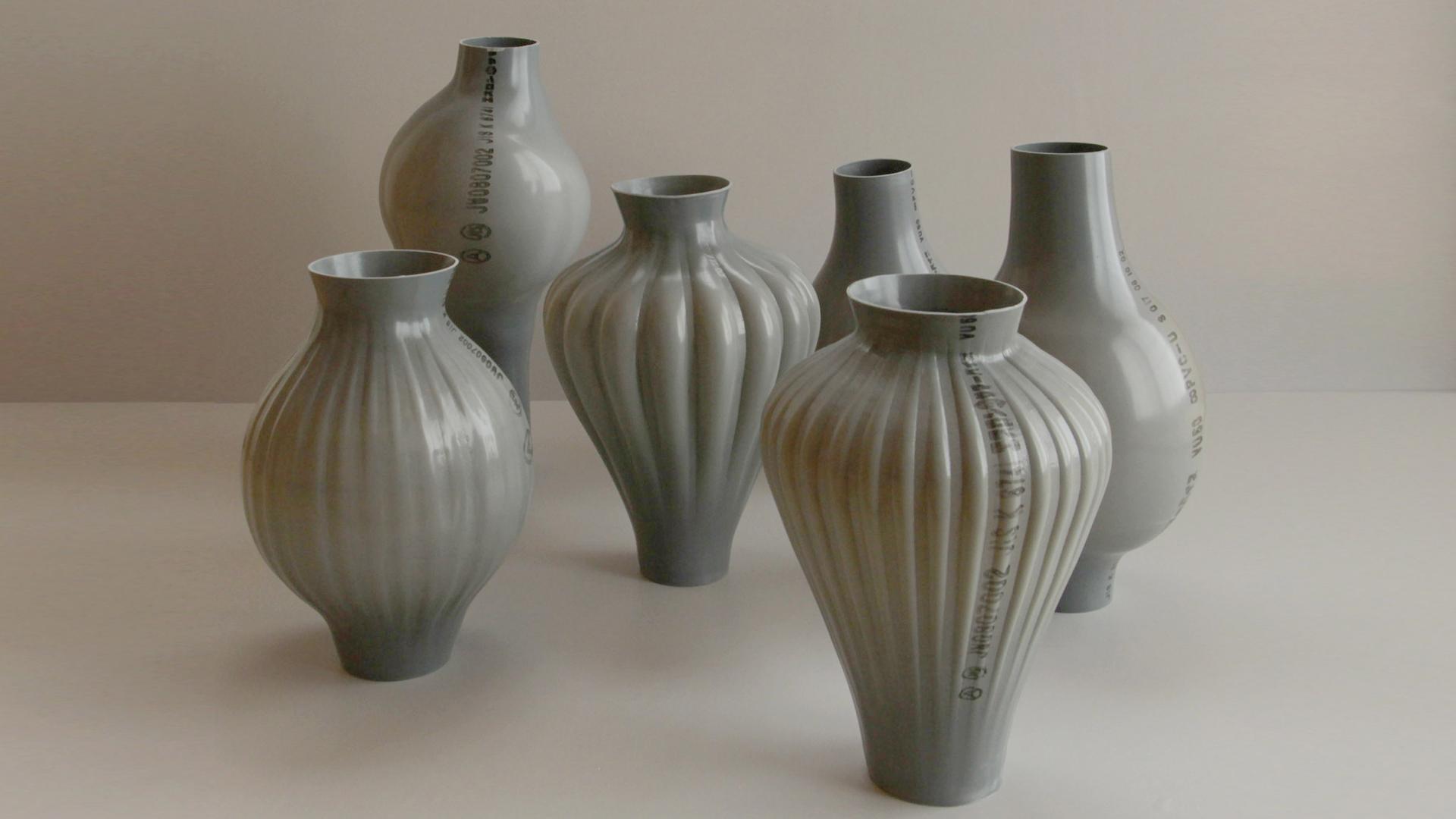 Unique vases made from recycled plastic displayed at London Design Fair, showcasing innovative sustainable design and material use.