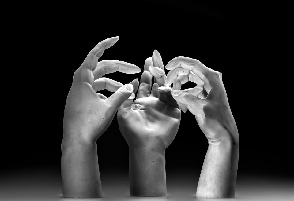 Sculptural representation of three artistic hands in varying positions, symbolizing modern craft and design at the Collect art fair.