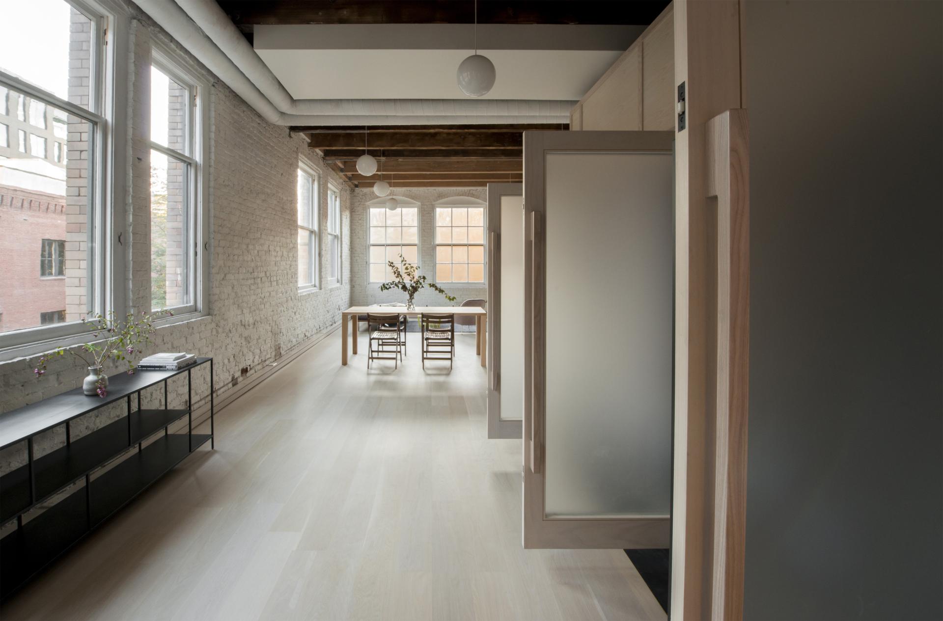 Stylish loft space in Pioneer Square featuring natural light, modern furnishings, and a minimalist design by Corey Kingston.