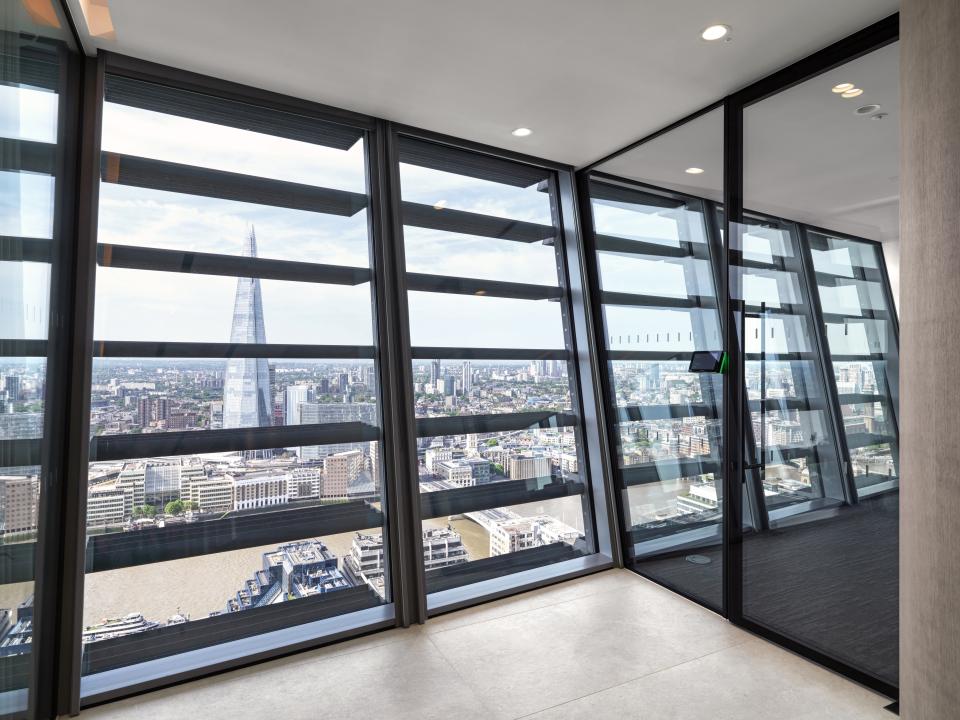 Curved glazed screens showcase panoramic views of London from Baker Botts' innovative office space by Radii.