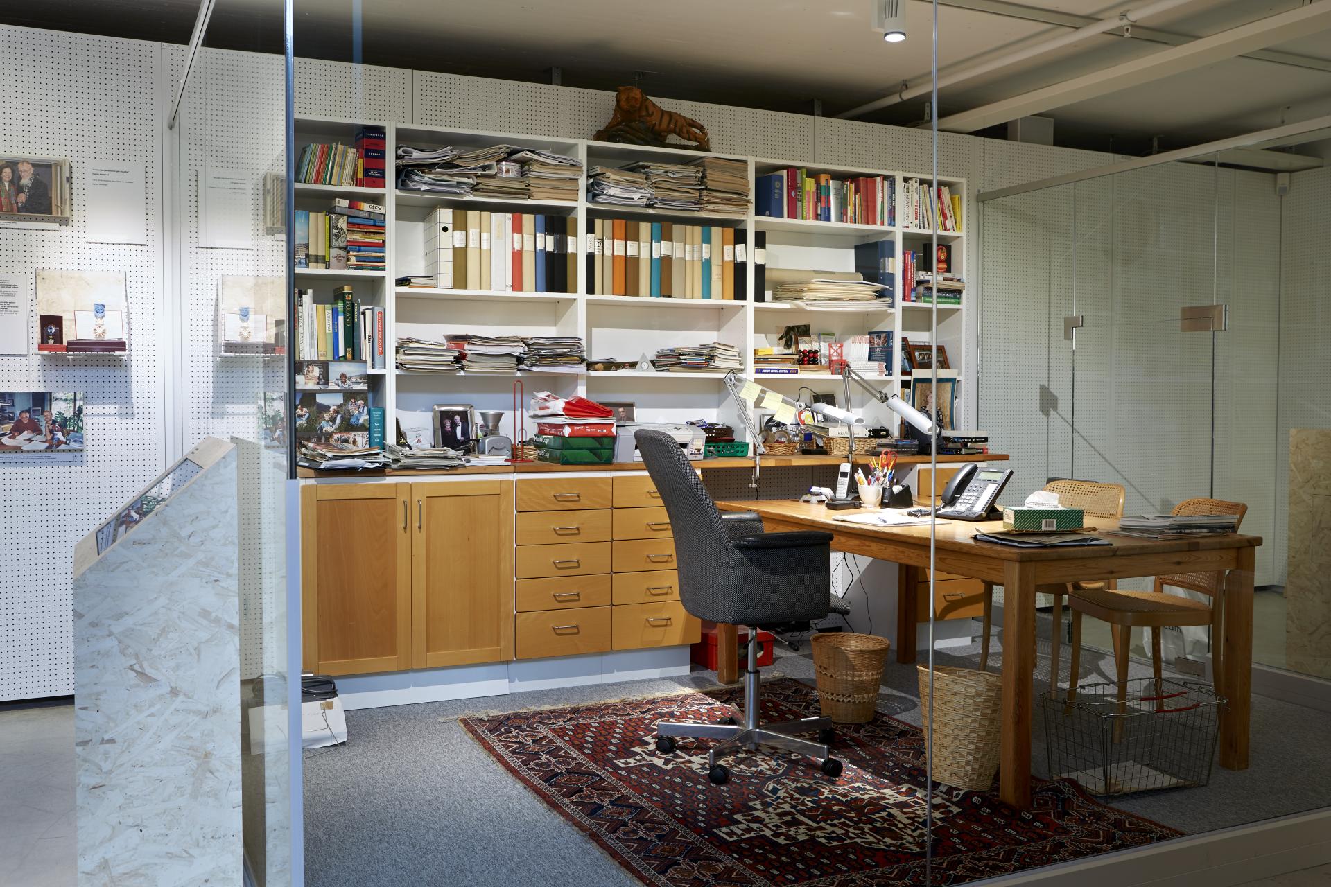 IKEA Museum exhibit featuring a cluttered office space with shelves, desk, and personal items reflecting the brand's history.