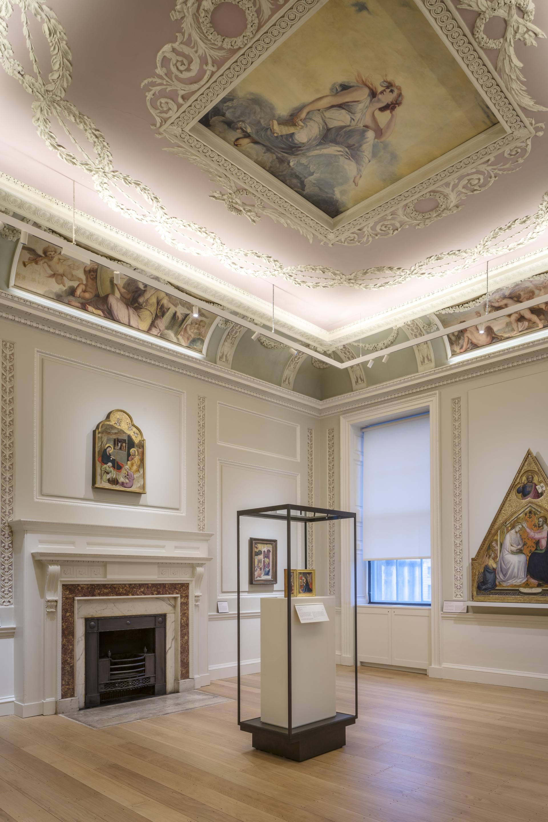 Elegant gallery interior of The Courtauld Gallery showcasing new design, artworks, and ornate ceiling details after renovation.