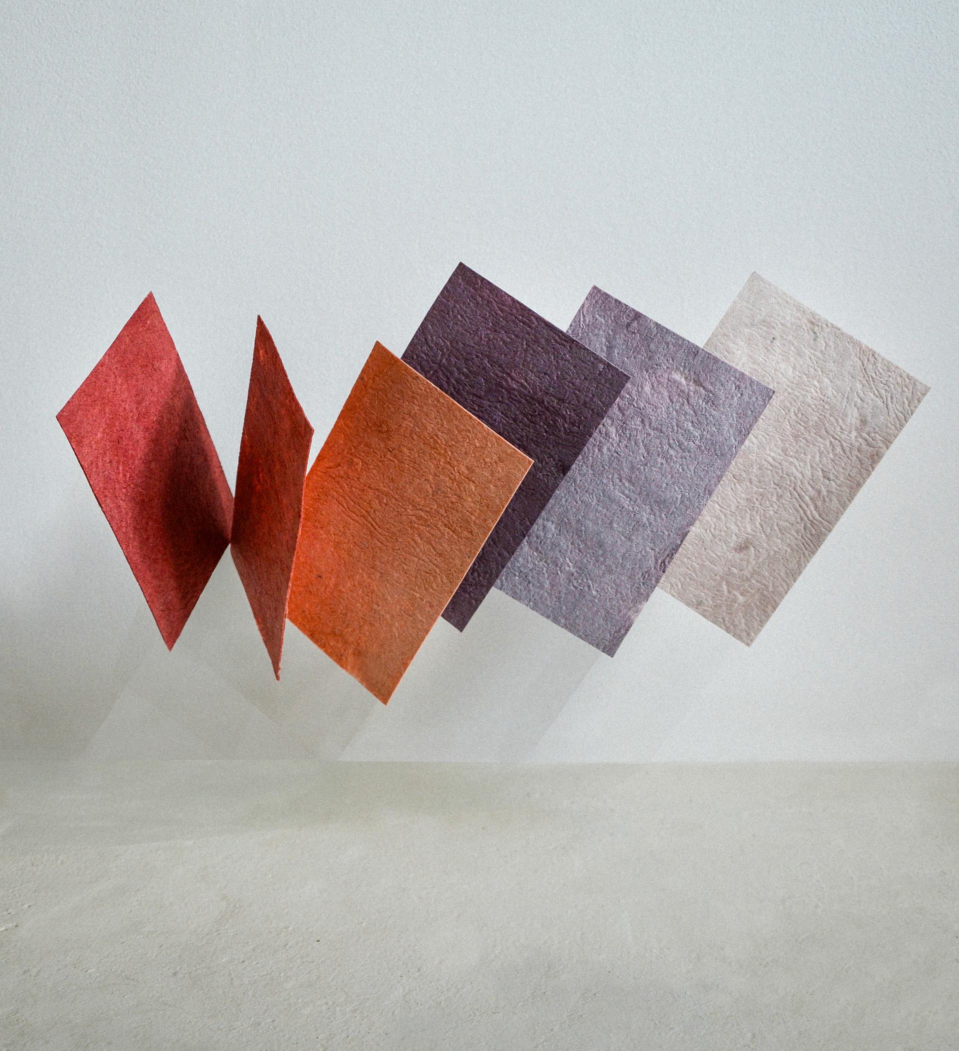 Colorful sheets of biomaterial showcase innovative design and sustainable practices by Studio Sarmite, emphasizing reimagined waste.