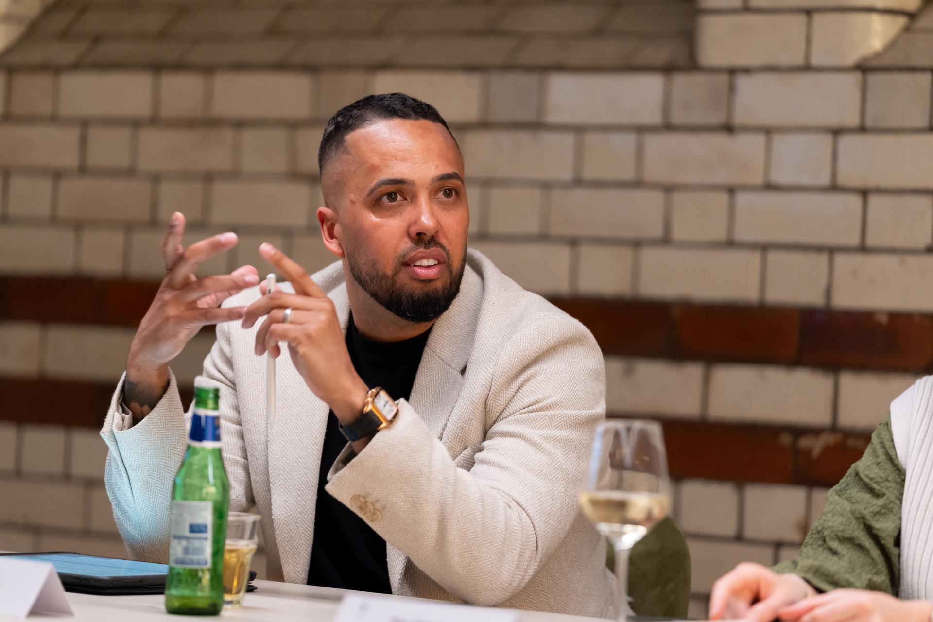 Engaged man discussing EDI culture at a roundtable, emphasizing collaboration and diversity in the workplace.