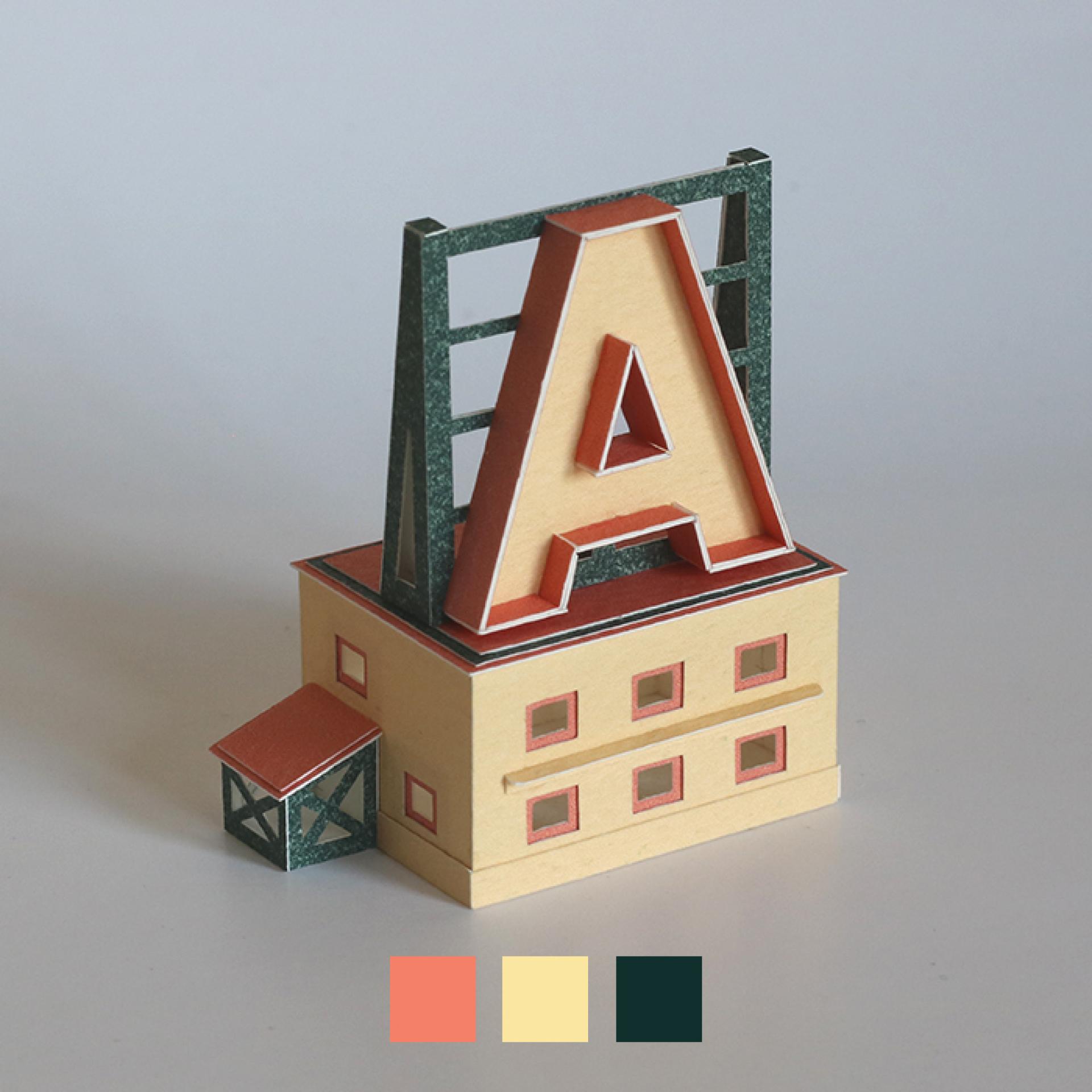 Colorful miniature model building featuring a prominent letter 'A' designed by storyteller Charles Young.