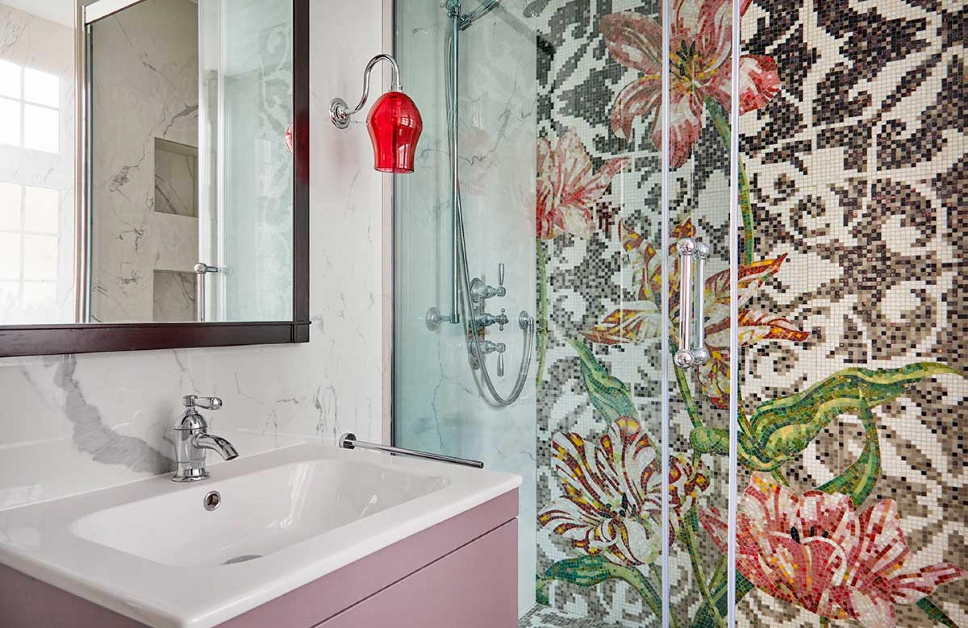 Brightly colored mosaic shower featuring floral designs, modern fixtures, and elegant marble accents in a Knightsbridge apartment.
