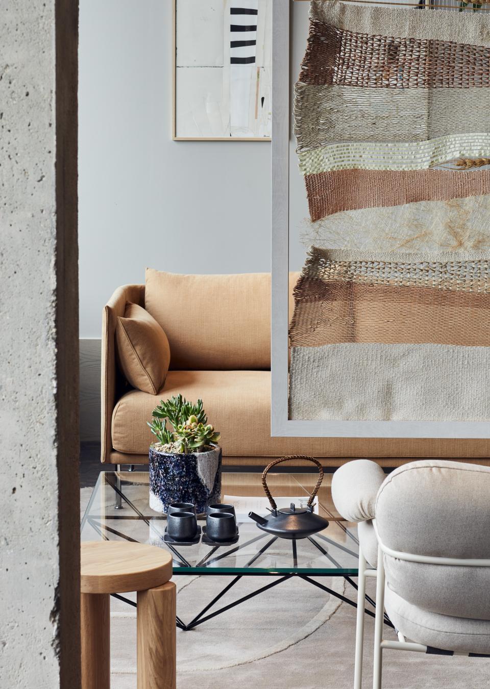 Stylish flexible workspace interior featuring a cozy sofa, decorative plants, and modern furniture in Notting Hill.