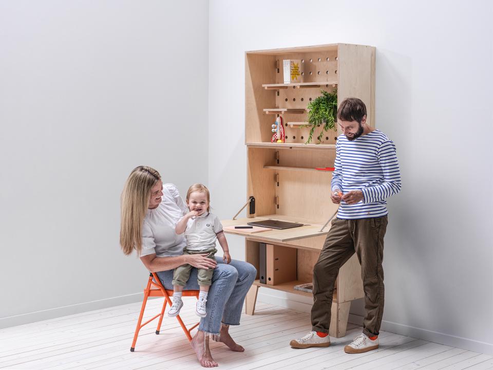Bespoke modular workspace featuring a mother and child with a man, highlighting flexible family-friendly design in Manchester.