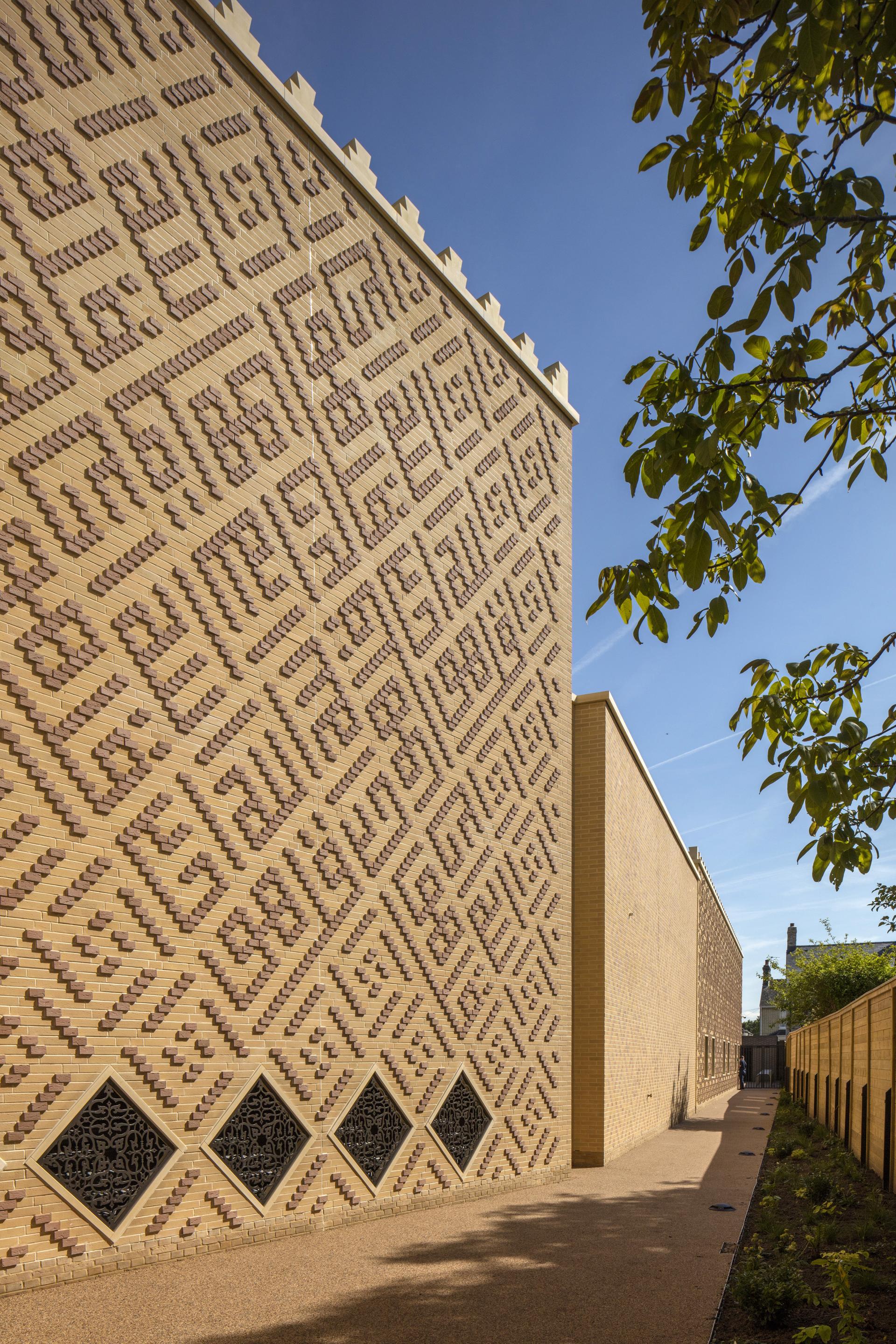 Textured brick wall with intricate patterns, showcasing innovative brick design celebrated in the 2019 Brick Awards.