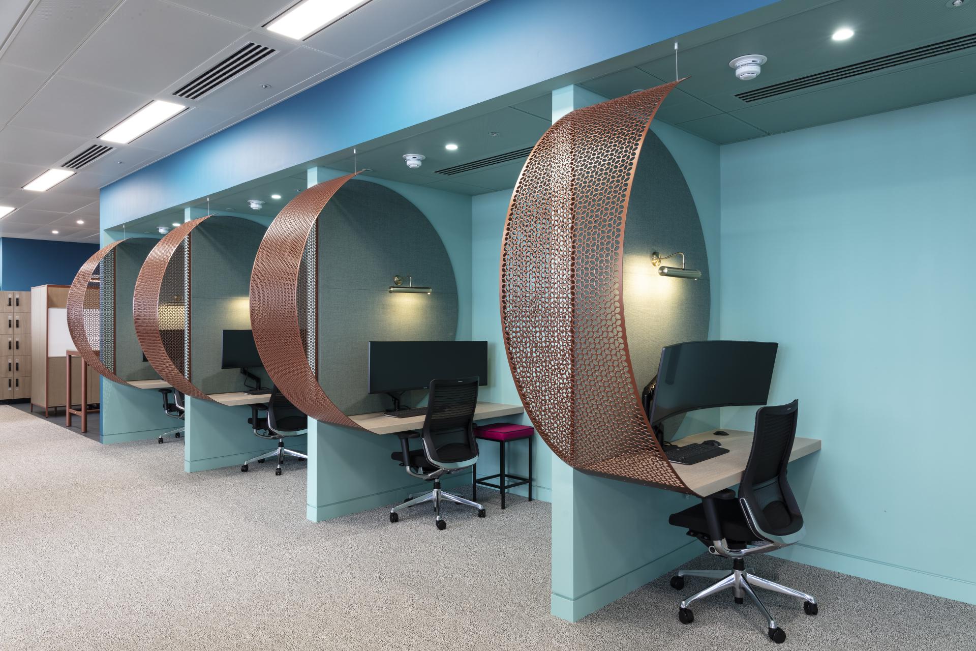 Modern office workstations with privacy screens and ergonomic chairs in Canopius’ new fit-out at 22 Bishopsgate, London.