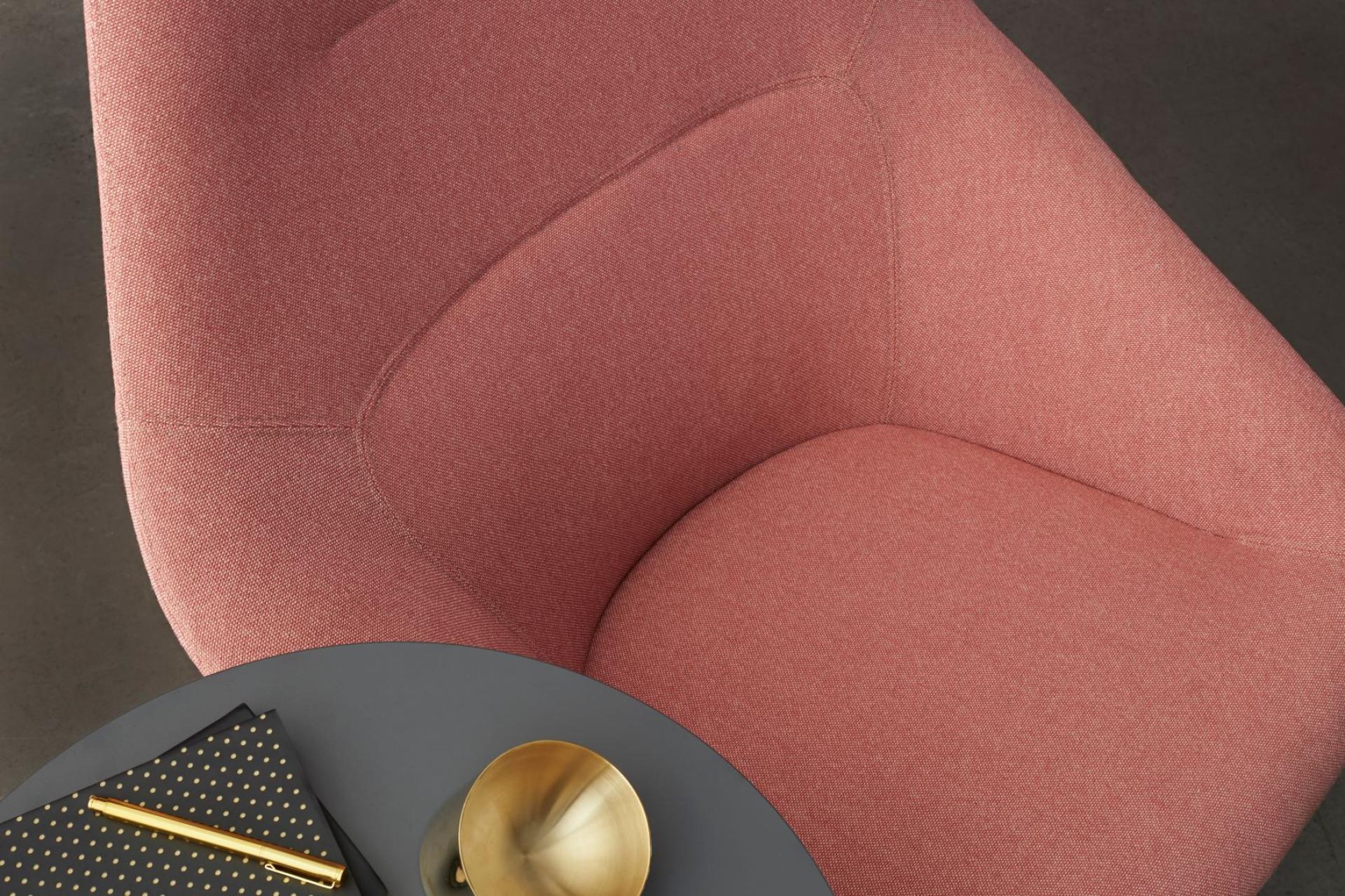 Wool-rich upholstery fabric in a soft pink hue, highlighting Woven Image's new Airport range of textiles alongside a stylish table setup.