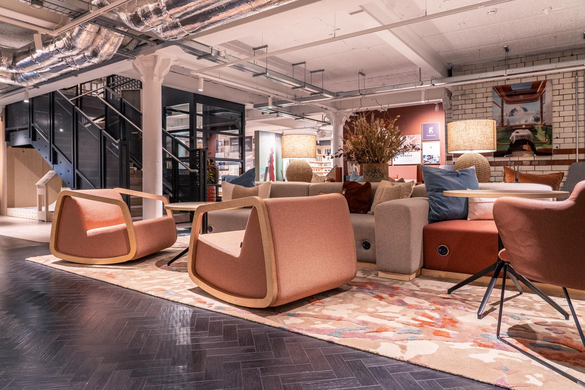 Bespoke Newhey rugs feature an organic color palette, complementing modern furniture in a stylish interior space.