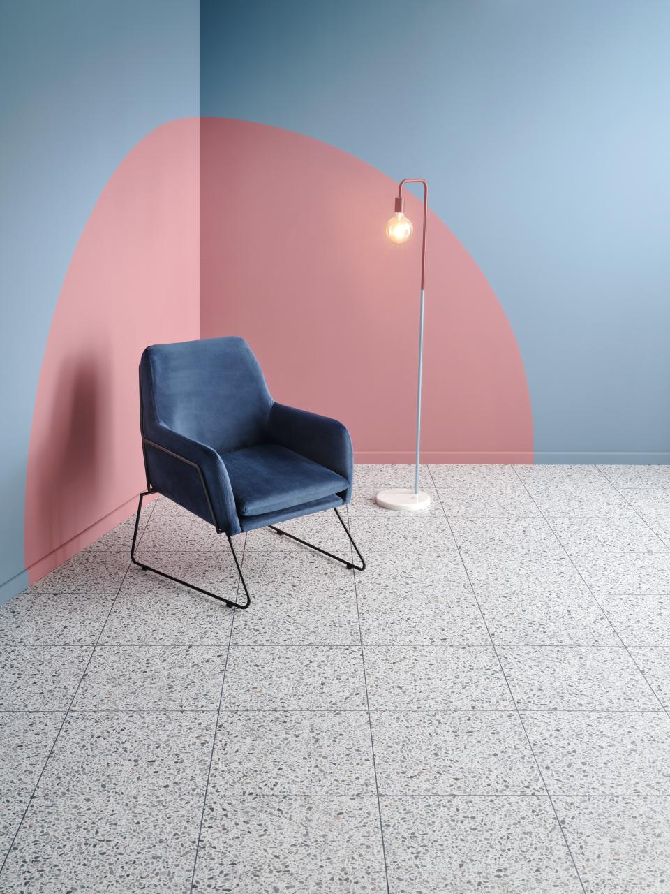 Stylish lounge setup featuring Amtico's Spacia luxury vinyl tile, a modern chair, and contemporary wall colors.