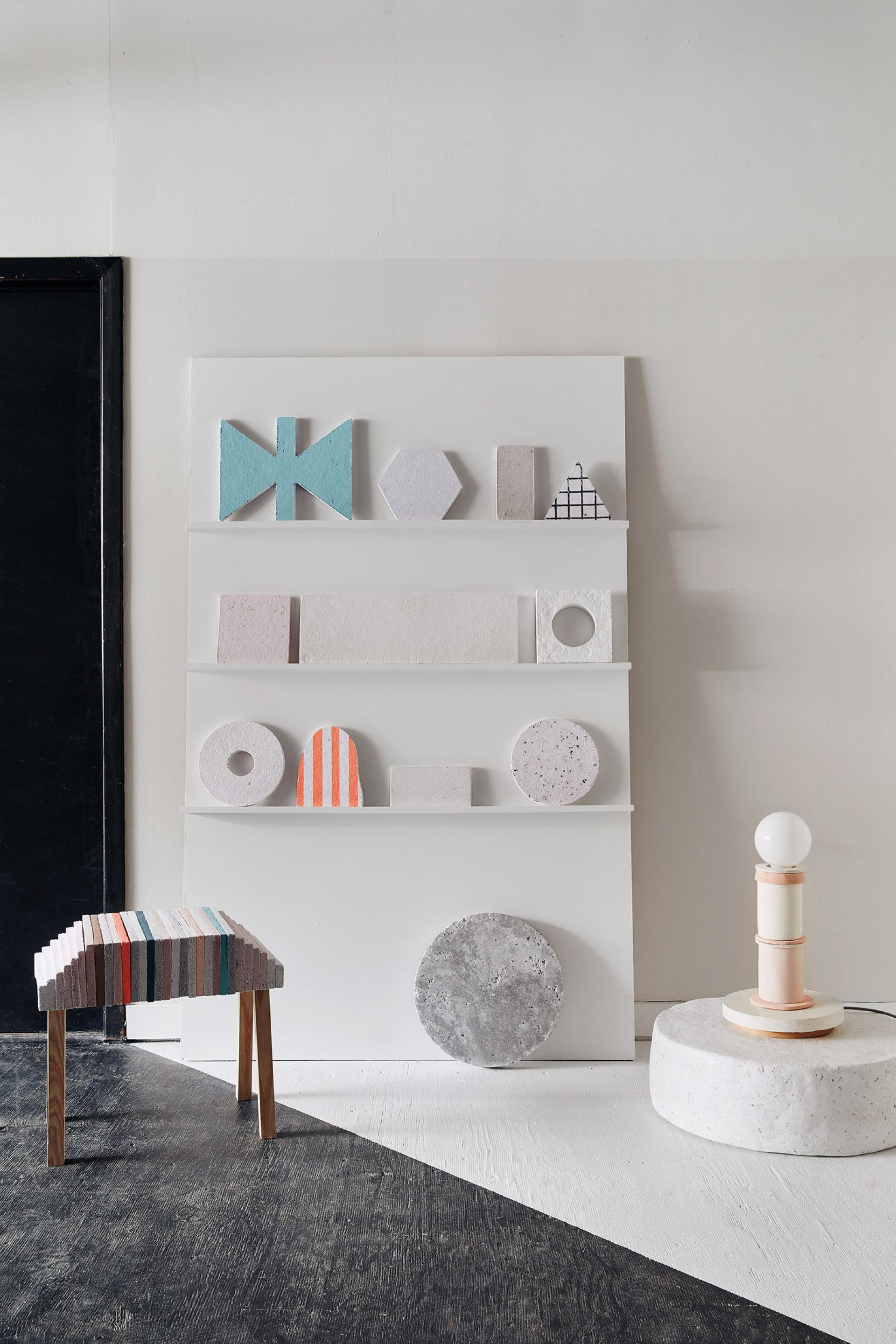 Colorful geometric sculptures and a textured stool designed by Dear Human, showcasing contemporary art and design aesthetics.