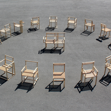 A circular arrangement of various wooden chairs constructed using 27mm square section timber during lockdown.