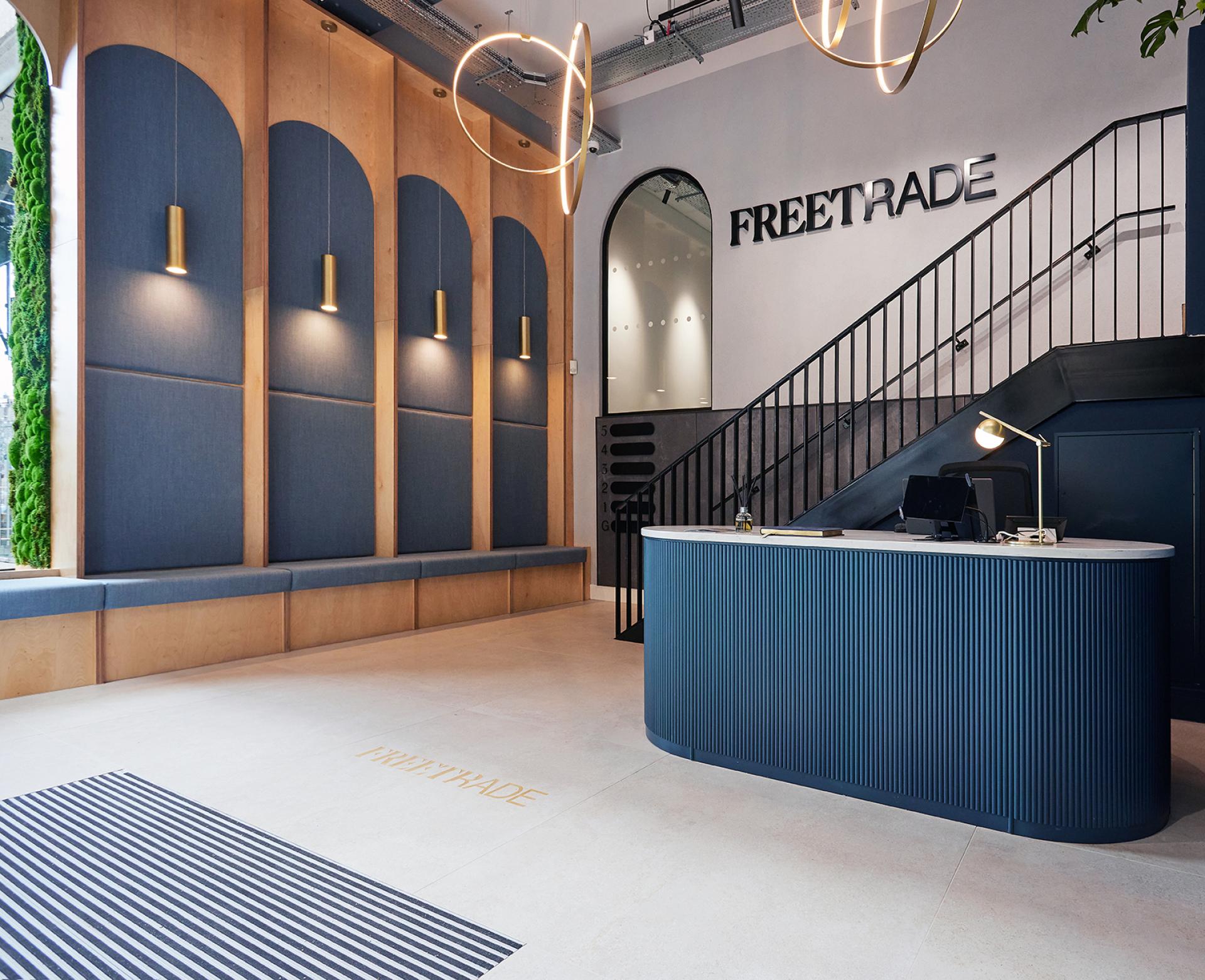 Modern office reception area of Freetrade, featuring stylish design elements and spacious layout, reflecting workplace culture priorities.