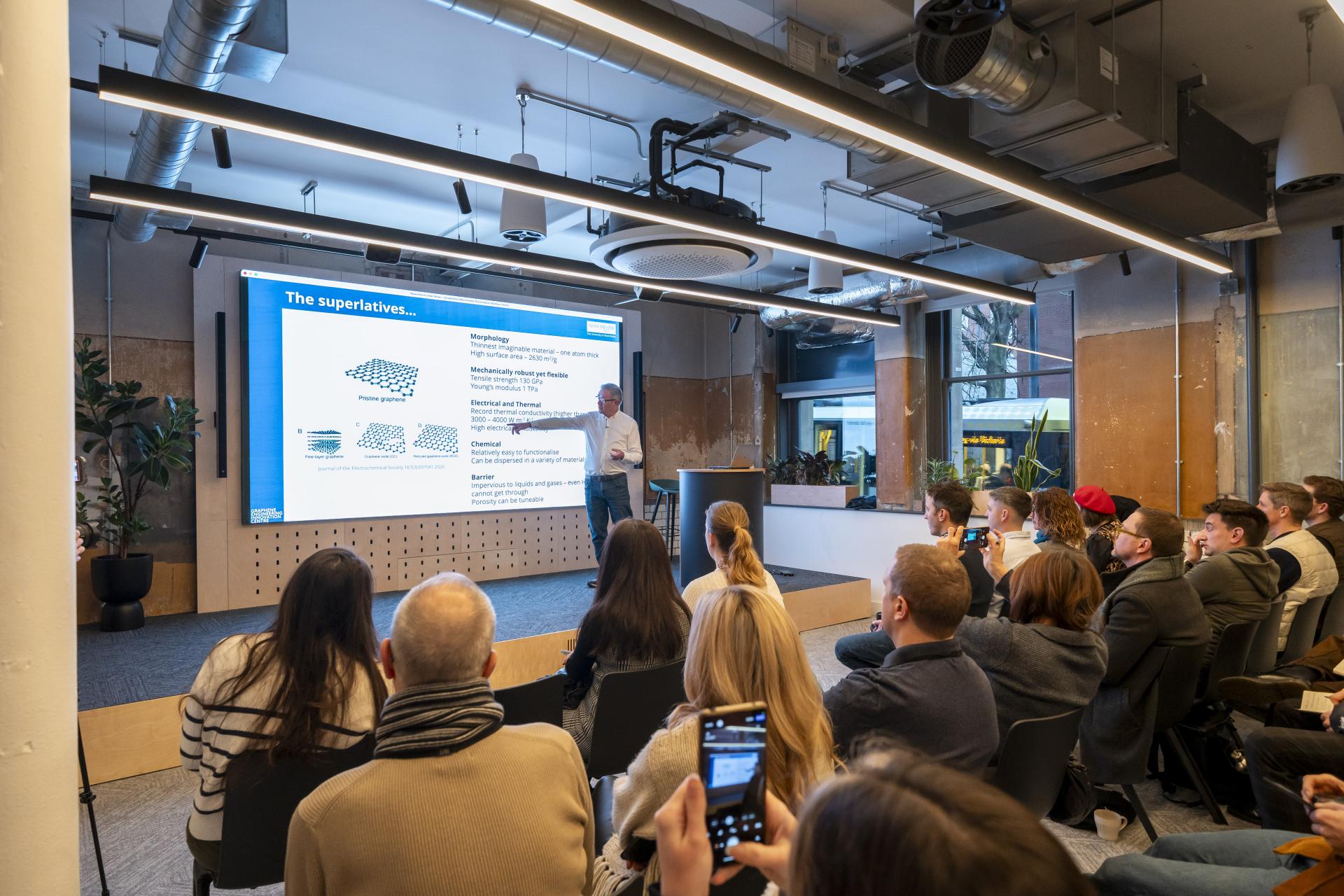 John Whittaker presenting on graphene properties to an engaged audience at the Graphene Engineering Innovation Centre.