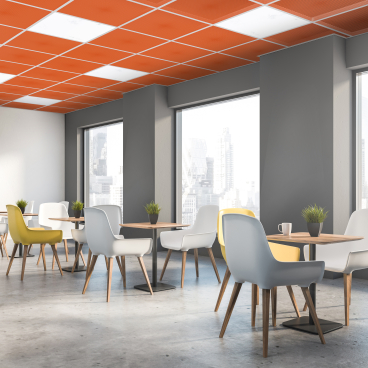 Bright and modern workspace showcasing Zentia's innovative ceiling design, featuring stylish chairs and panoramic city views.