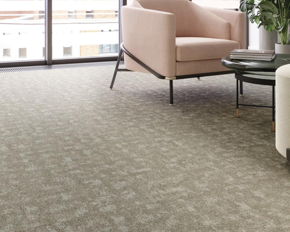 Modern interior featuring Forbo's Tessera Union collection flooring, a soft textured surface with stylish furniture arrangement.