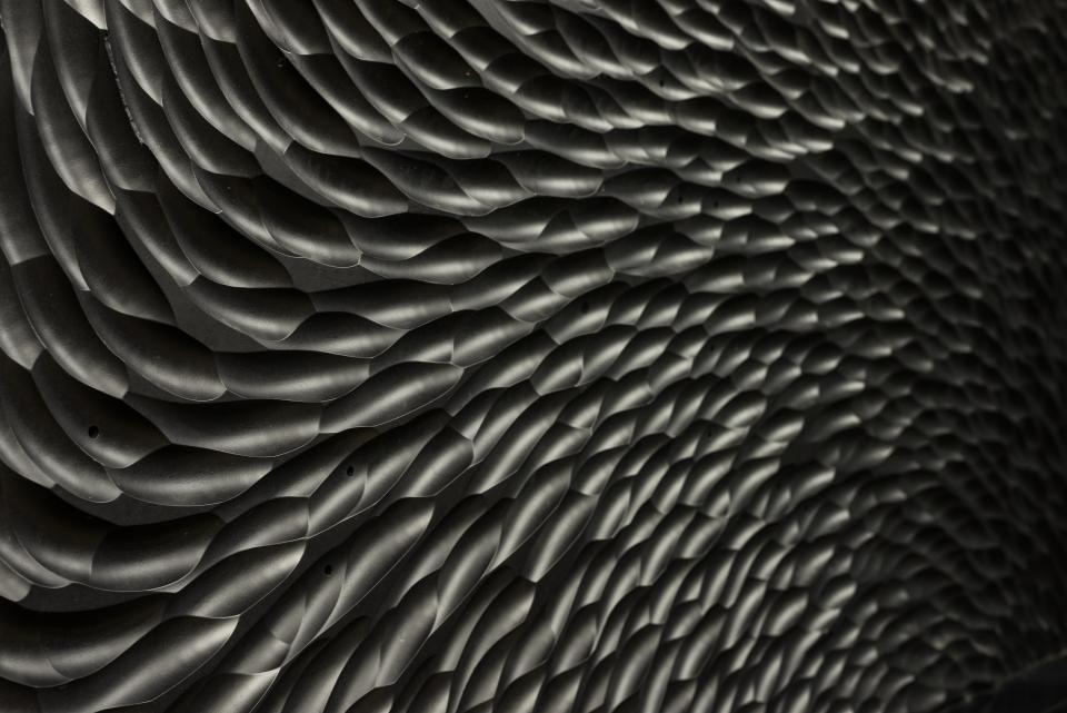 Dynamic textured wall design featuring an intricate pattern, relevant to innovative architecture showcased in Surface Design Awards 2019.