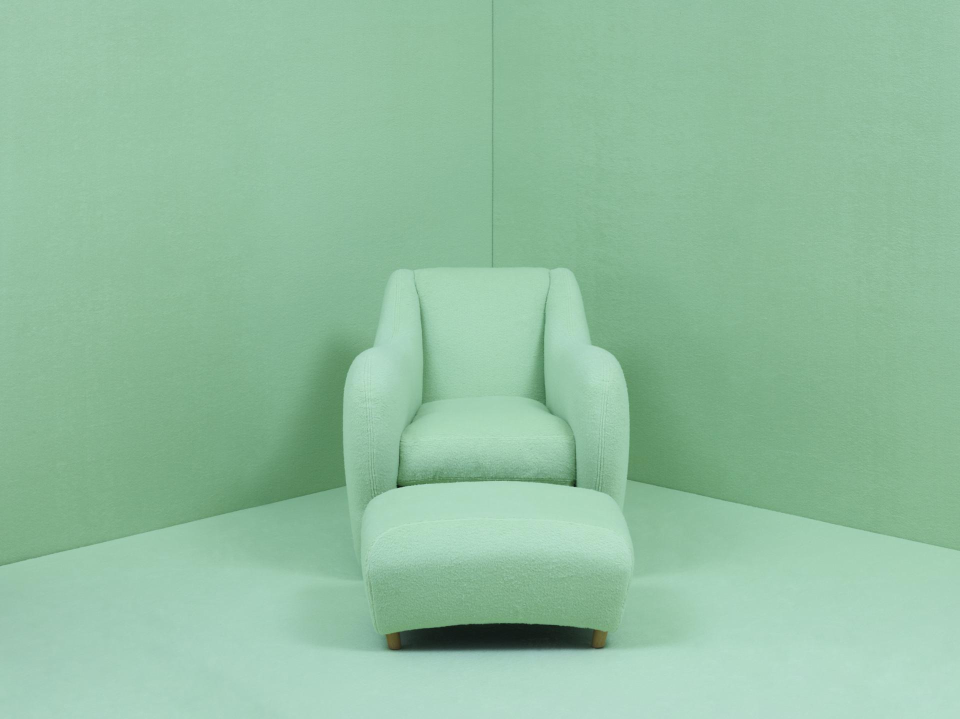 Balzac armchair by Matthew Hilton in pastel green, showcasing its soft fabric and sleek design for 30th anniversary celebration.