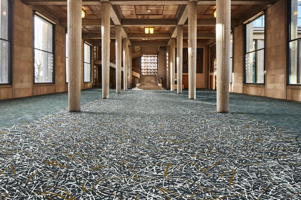Elegant interior featuring Forbo's Flotex By Starck flooring, showcasing a modern design with intricate patterns.