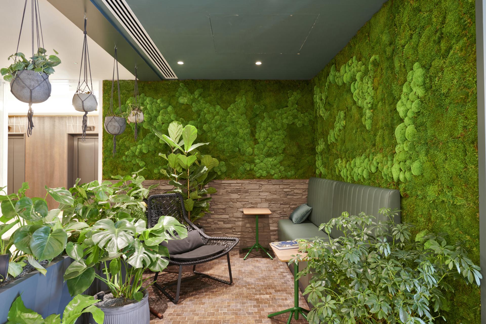Elegant nature-inspired interior design with lush greenery and a moss wall at One Victoria Street, Windsor.