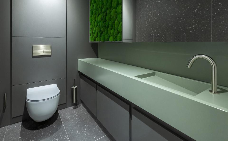 Modern eco-friendly restroom featuring a sleek design, natural elements, and sustainable materials for a healthy workplace environment.