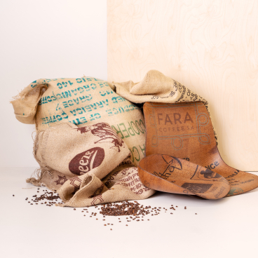Unique furniture made from transformed coffee bags, showcasing sustainable design by Vepa and Peeze with scattered coffee beans.
