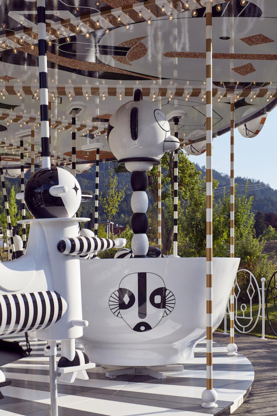 Artistic carousel design by Jaime Hayon featuring playful, abstract characters in black and white, evoking freedom and joy.