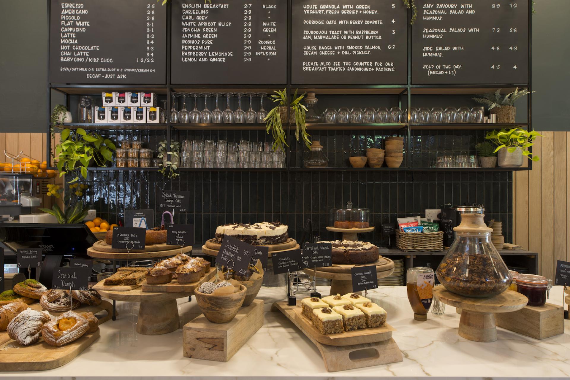Delicious assortment of pastries and cakes displayed at Spicer & Cole, Bristol's Royal West of England Academy café.