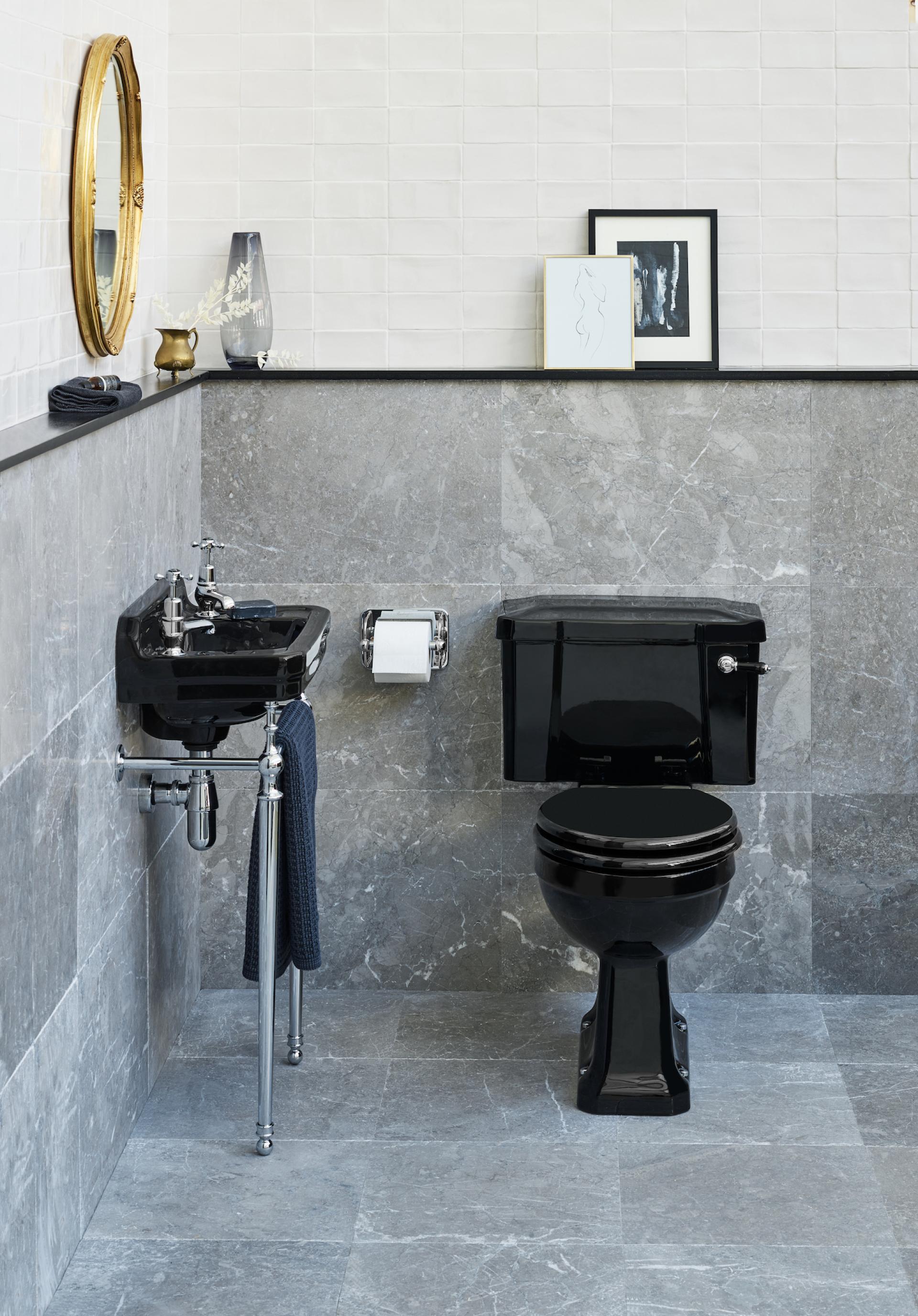 Sleek black bathroom fixtures paired with elegant gray tiles and modern decor highlight 2022's top bathroom trends.