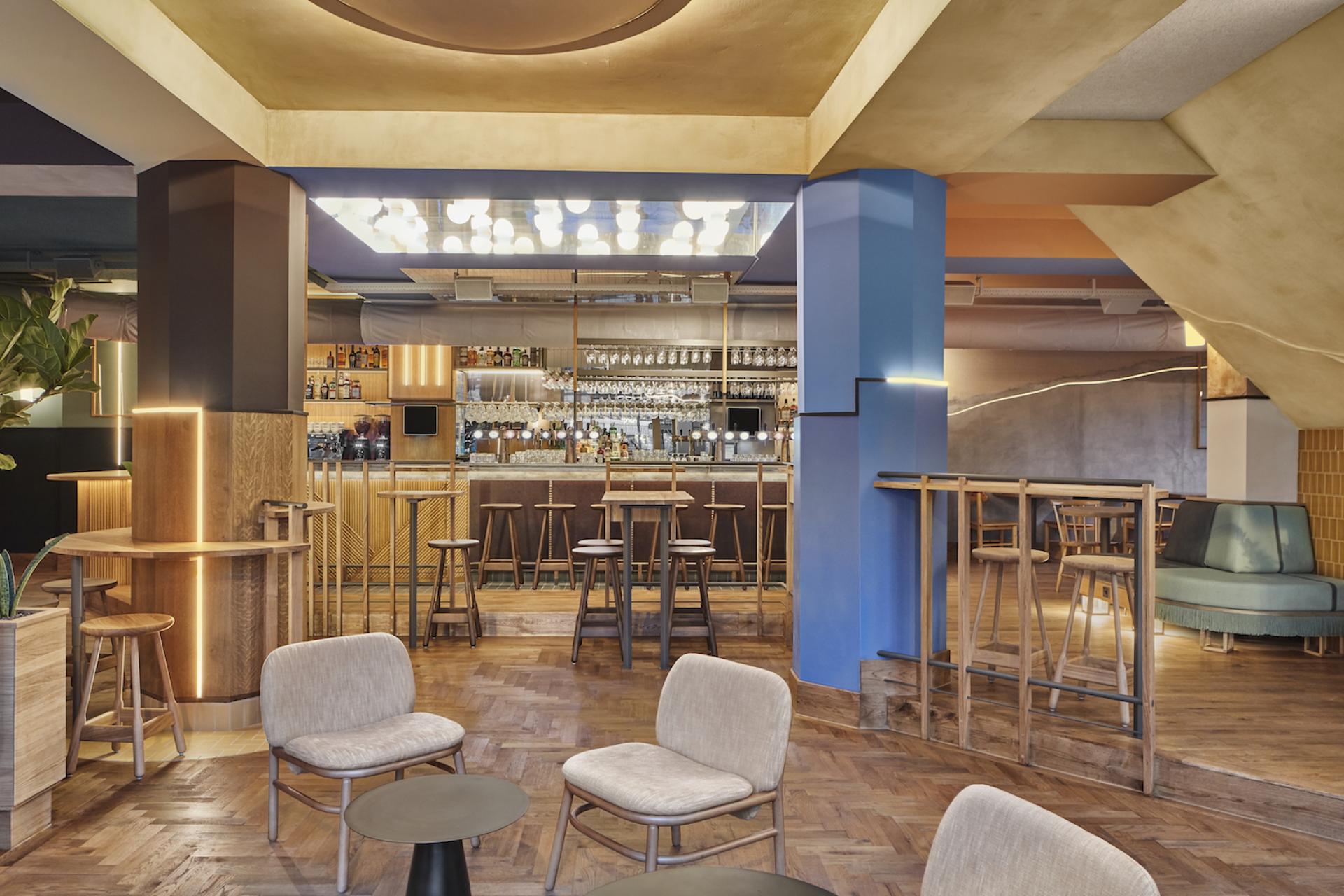 Interior of Karavaan bar and restaurant in Amsterdam, featuring stylish seating and a well-stocked bar, designed by Studio Modijefsky.