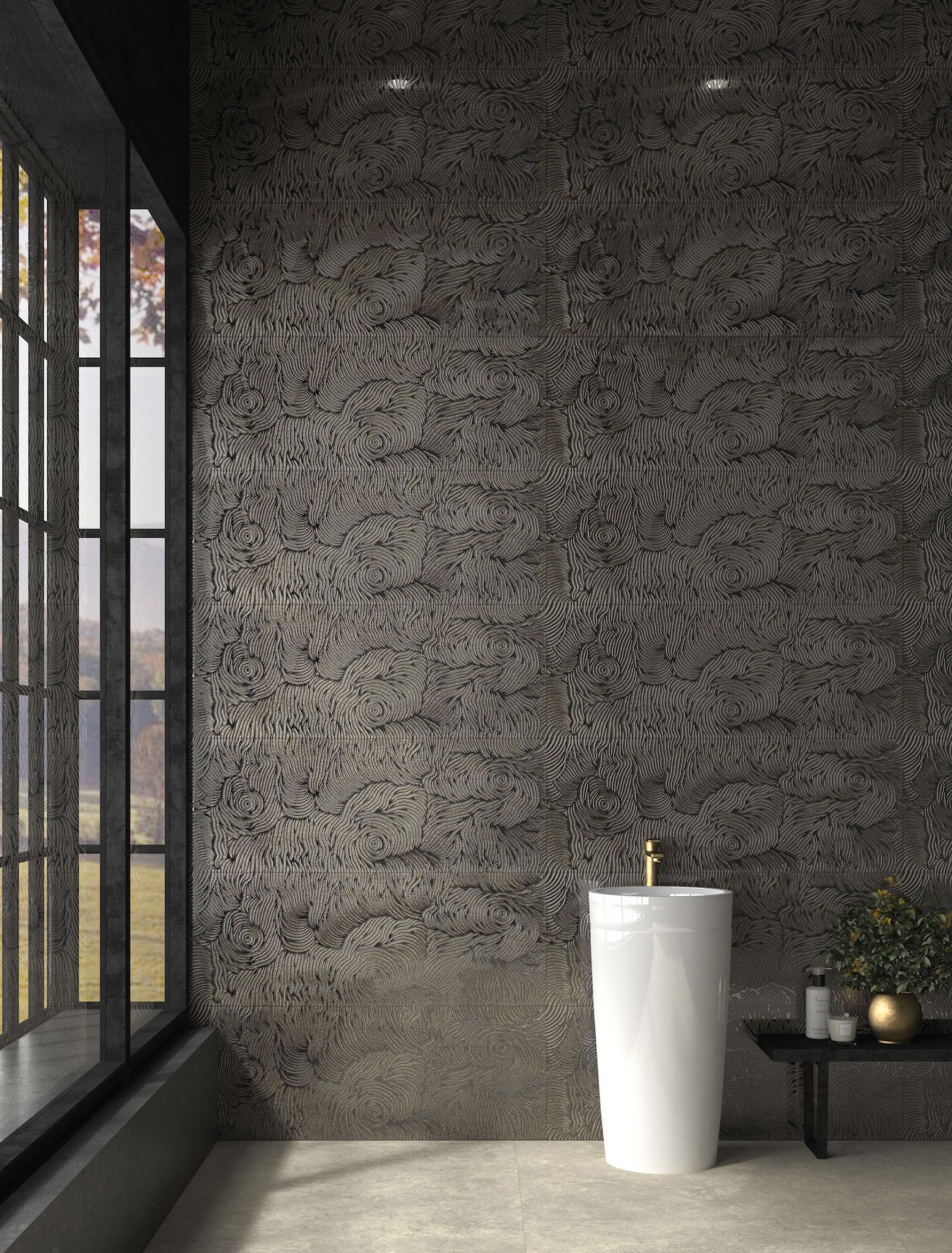 Stylish bathroom featuring textured dark gray tiles and a white freestanding sink, highlighting modern Spanish tile trends.