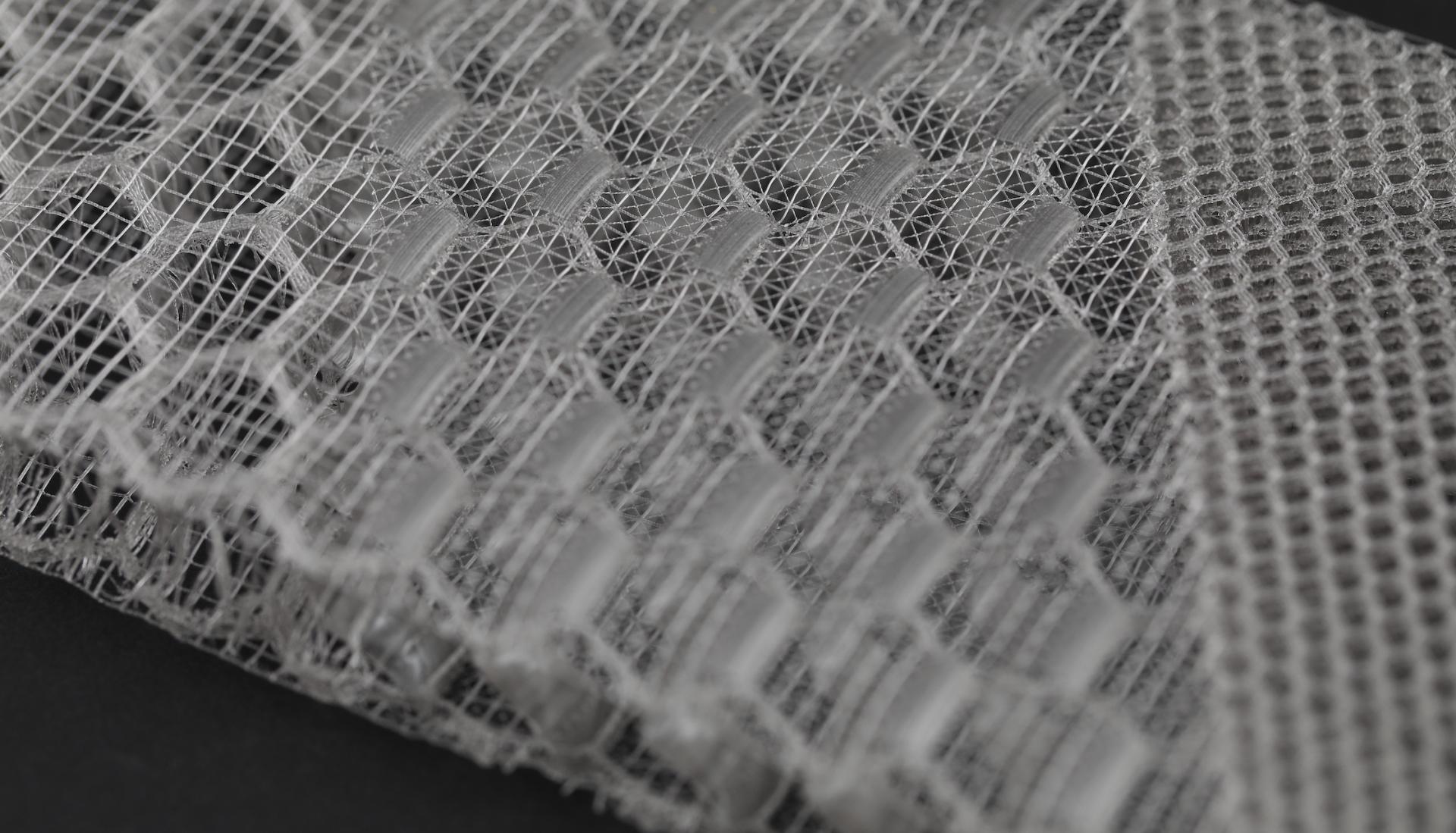 Innovative 3D-printed material showcasing intricate honeycomb and lattice structures developed by OPT Industries for sustainable applications.