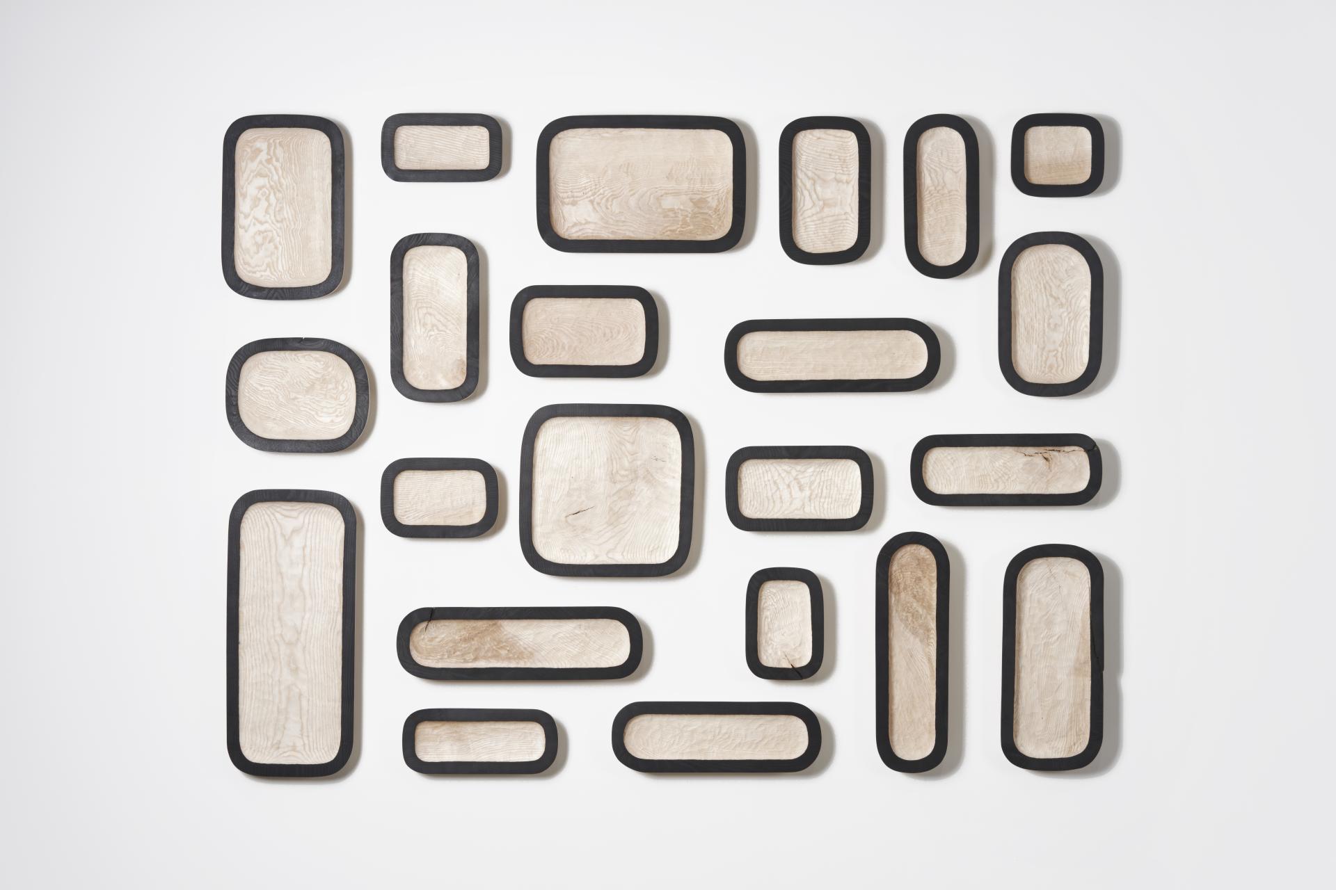 Artistic arrangement of ash wood trays highlighting Scotland’s native ash tree craftsmanship and environmental significance.