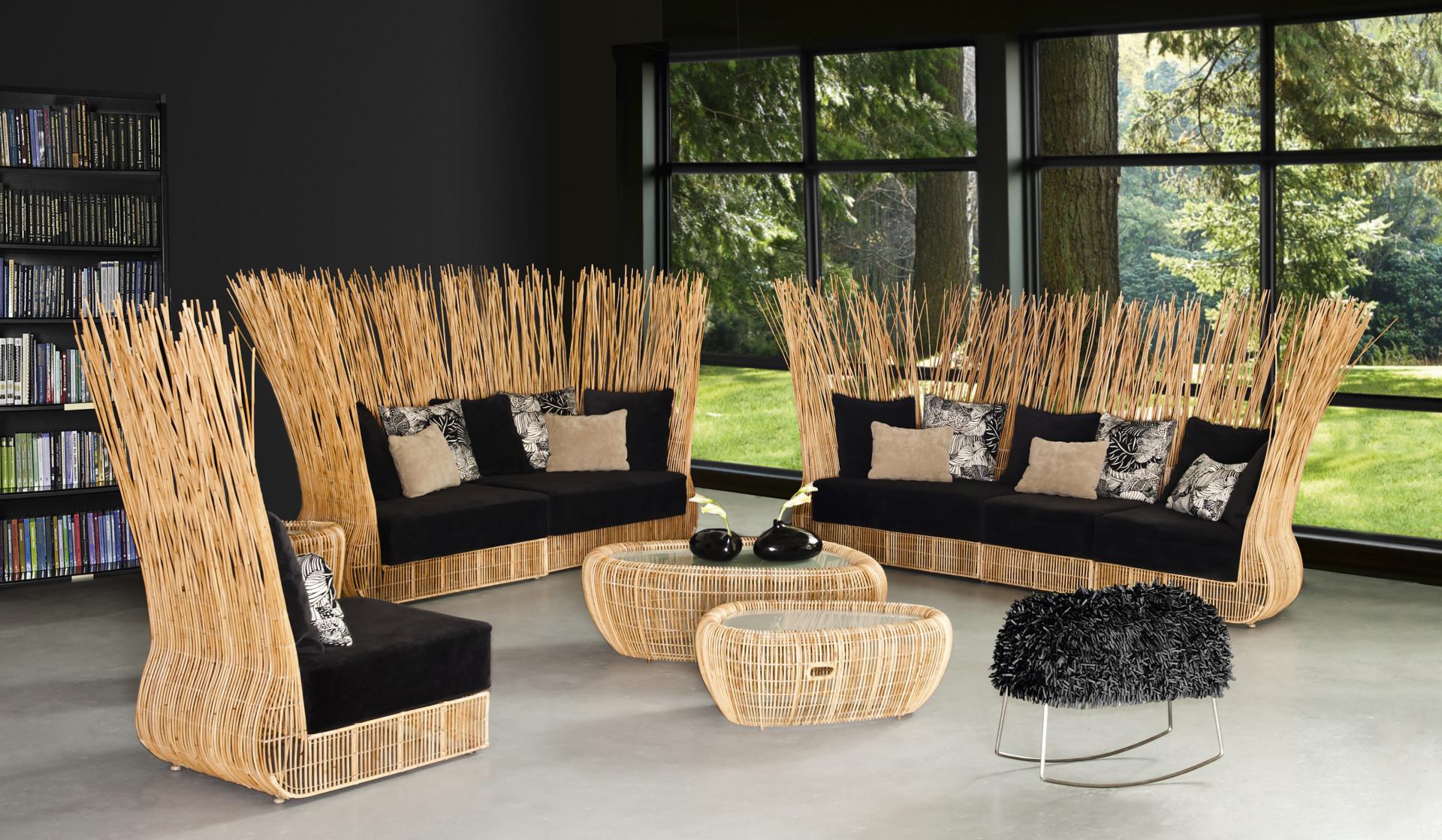 Sculptural furniture set inspired by nature, featuring rattan seating with black cushions and an organic design in a modern interior.