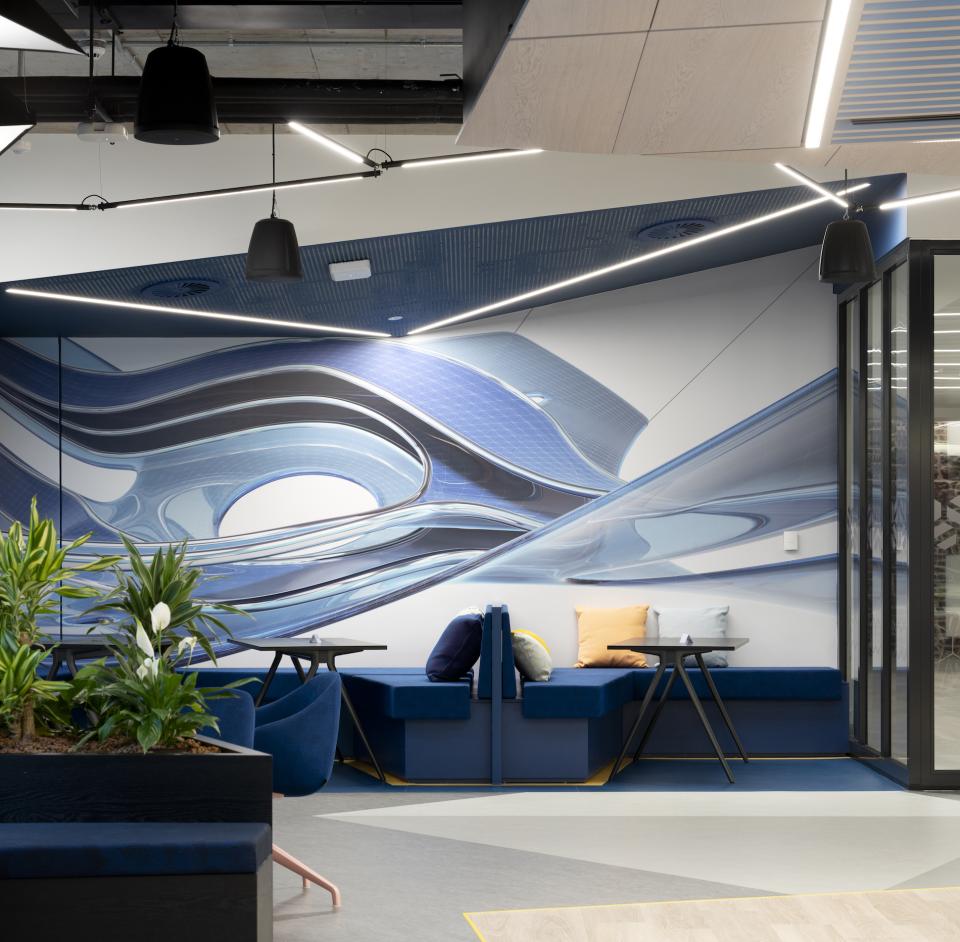 Modern office interior featuring Martinelli Luce lighting design and abstract wall art at Autodesk headquarters in Dublin.