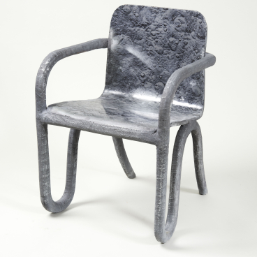 Sculptural chair designed by Matthew Day Jackson, featuring a lunar-inspired texture and contemporary form, showcased at Milan Design Week.