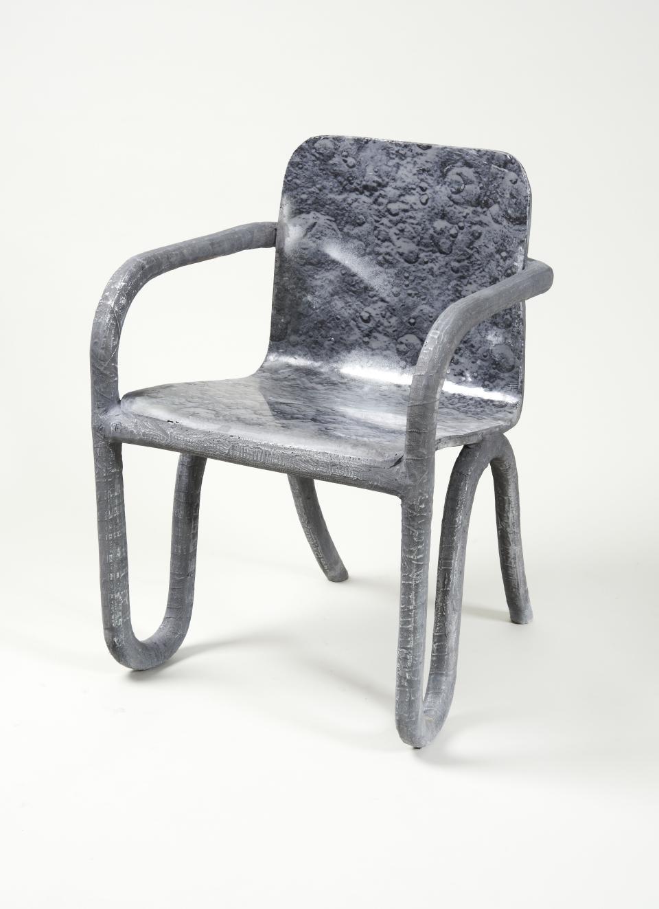 Sculptural chair designed by Matthew Day Jackson, featuring a lunar-inspired texture and contemporary form, showcased at Milan Design Week.