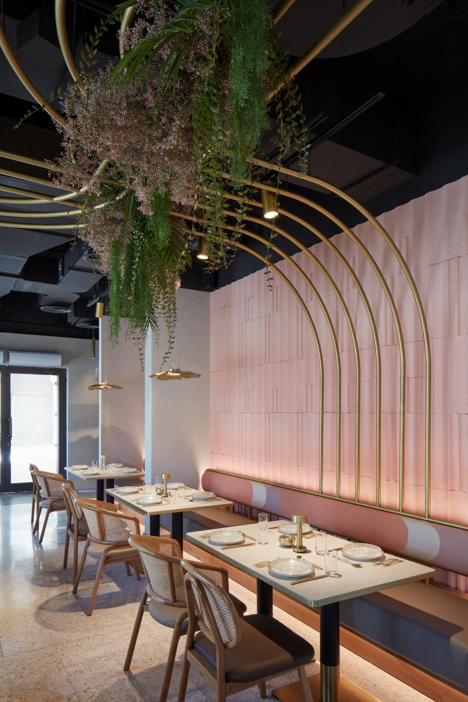 Contemporary interior of Mezza House restaurant in Dubai, featuring elegant furnishings and lush greenery decor.