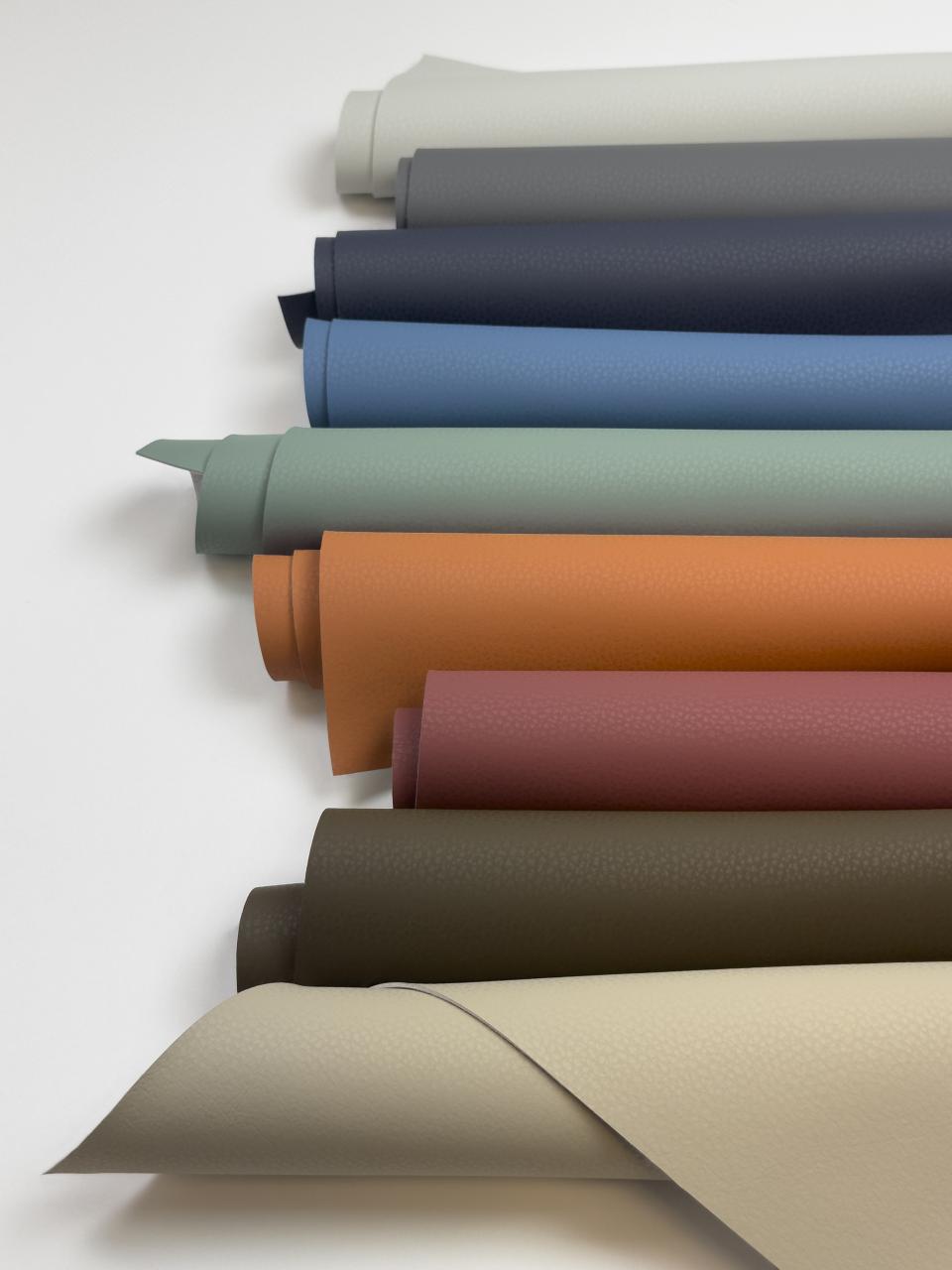 Volar Bio collection showcasing various eco-friendly synthetic fabrics in diverse colors and textures on a white background.