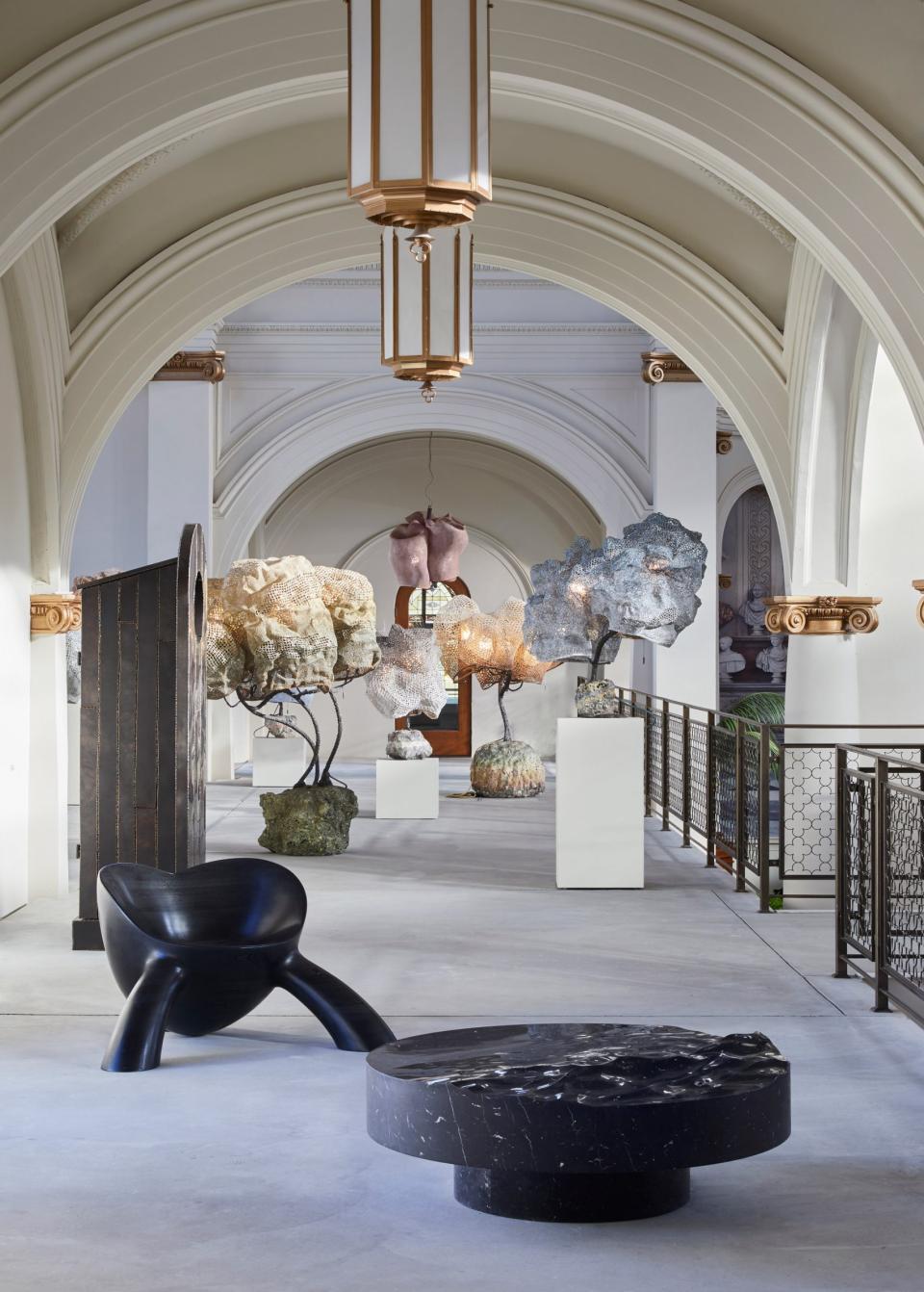 Artistic interior view of Carpenters Workshop Gallery showcasing contemporary sculptures and unique furniture in a renovated church.