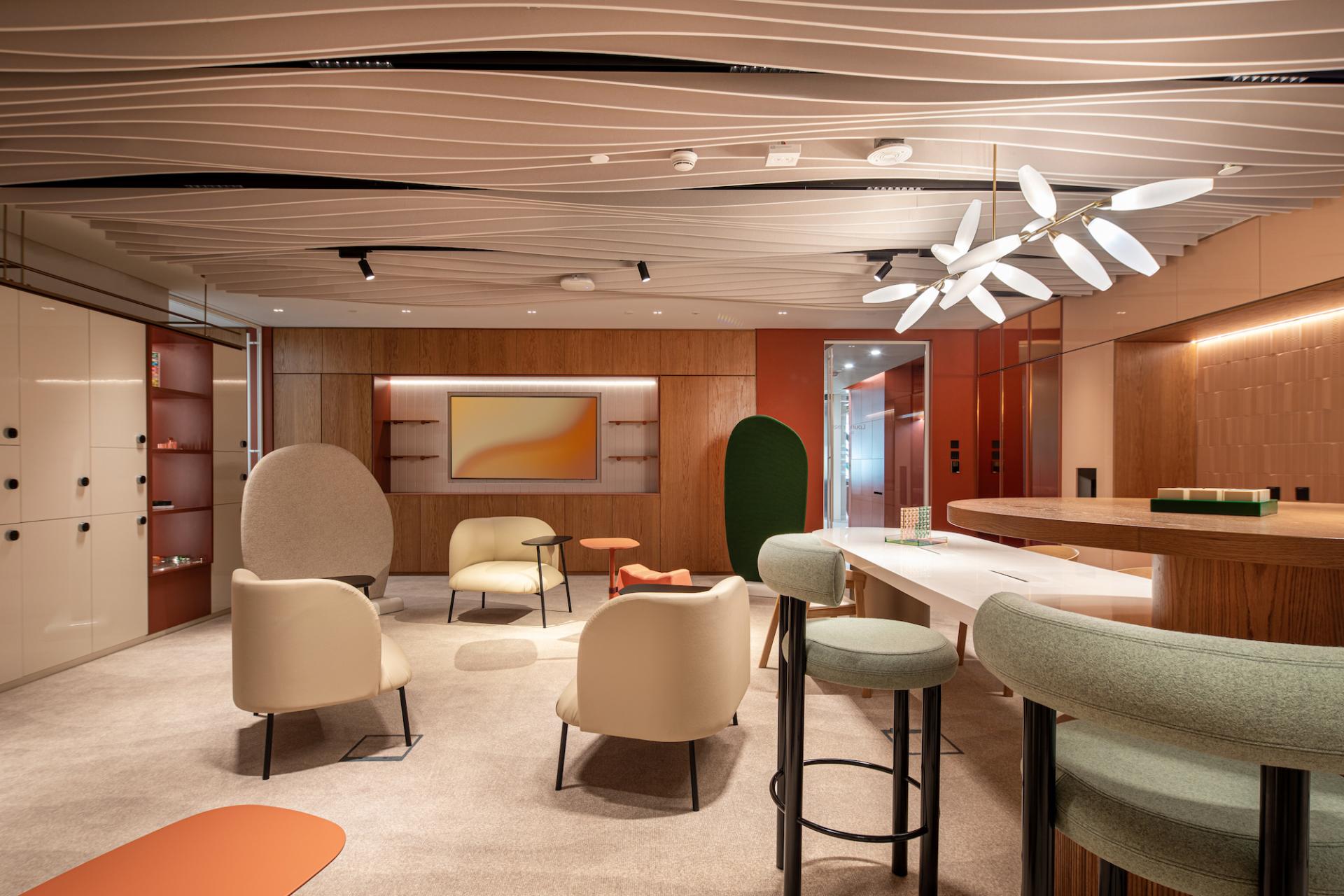 Modern workplace in Dubai featuring colorful seating, natural light, and nature-inspired design elements that elevate employee well-being.